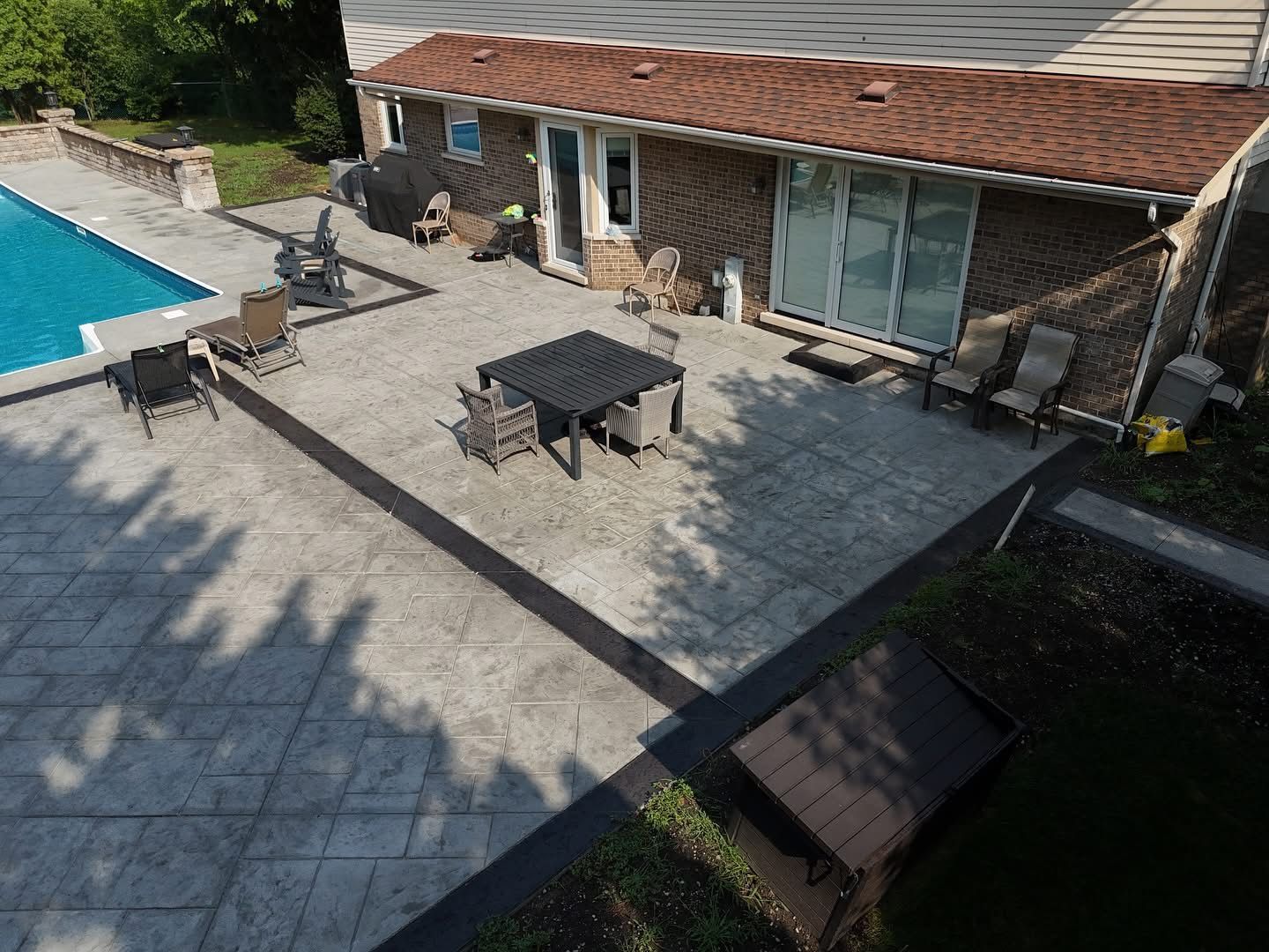 Construction of a concrete walkway around a residential rural house in manual of the pavement with a special tool.