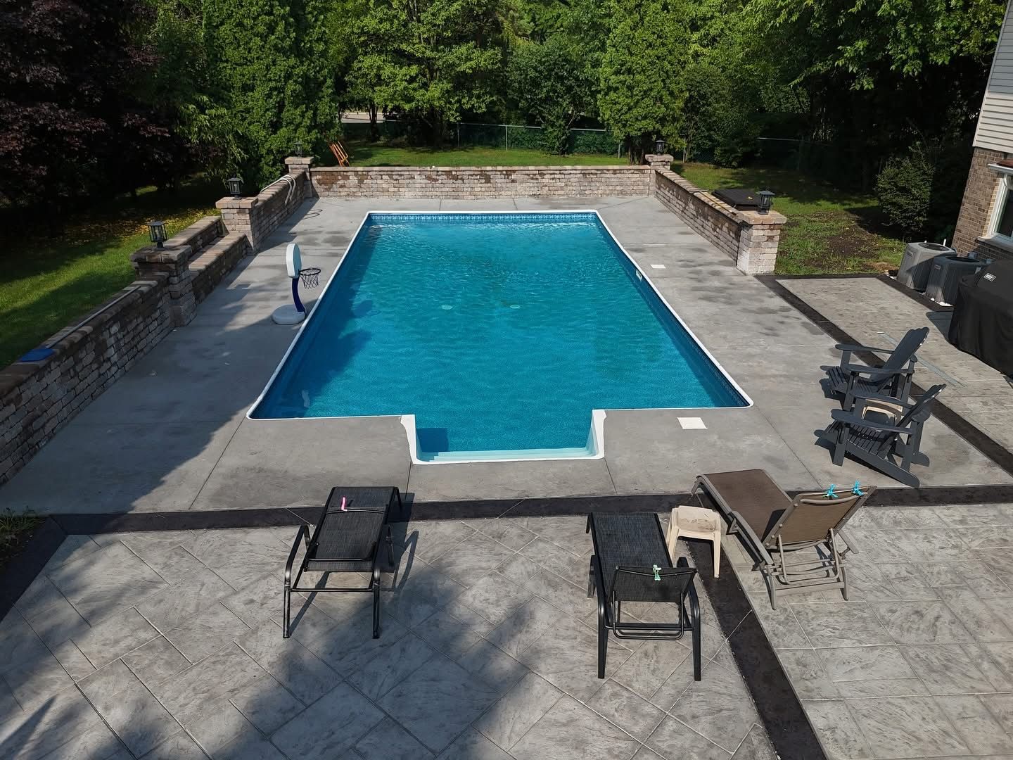 Umbrella and chair around outdoor swimming pool in resort hotel for vacation leisure.