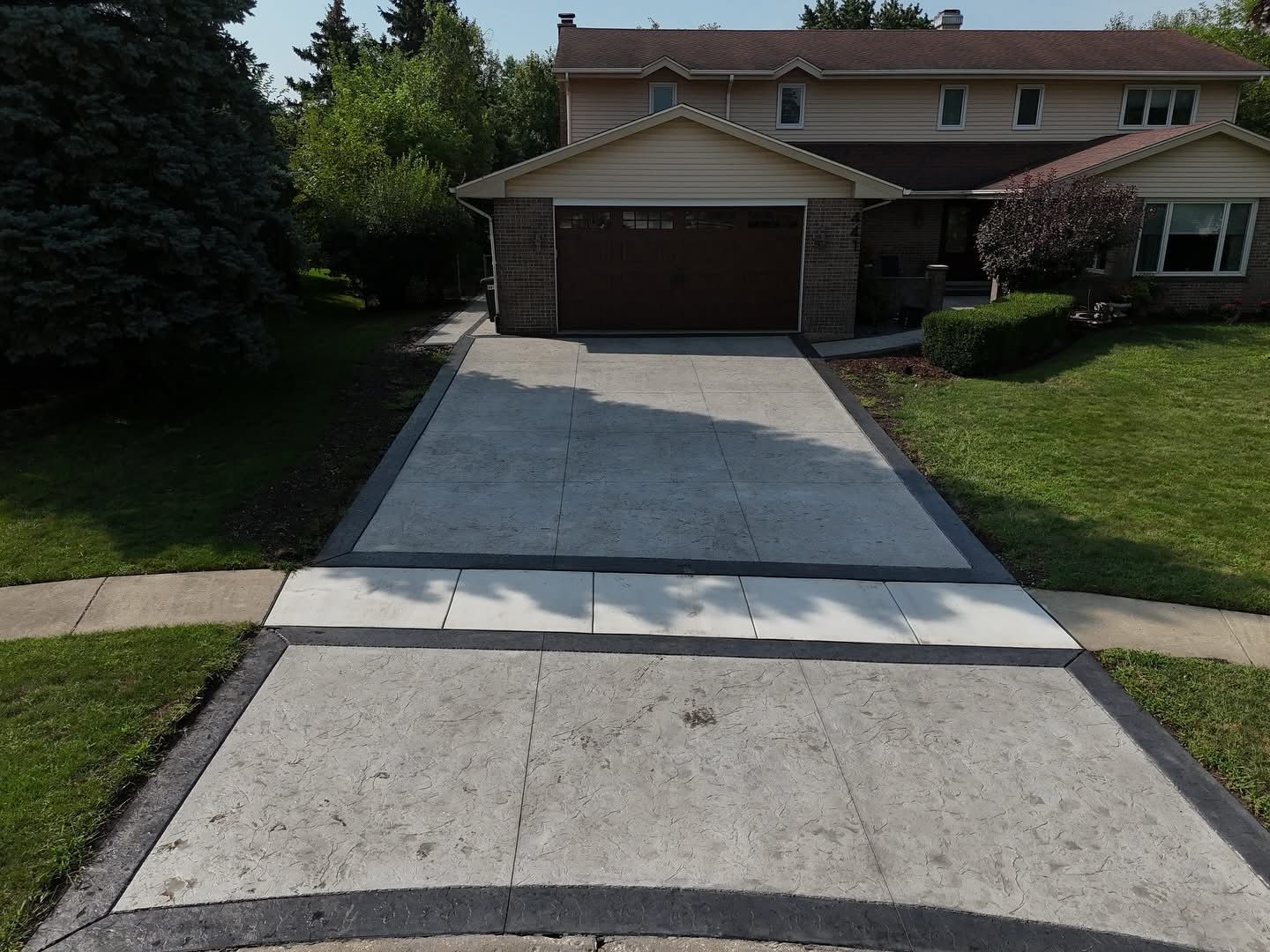 Construction of a concrete walkway around a residential rural house in manual of the pavement with a special tool.