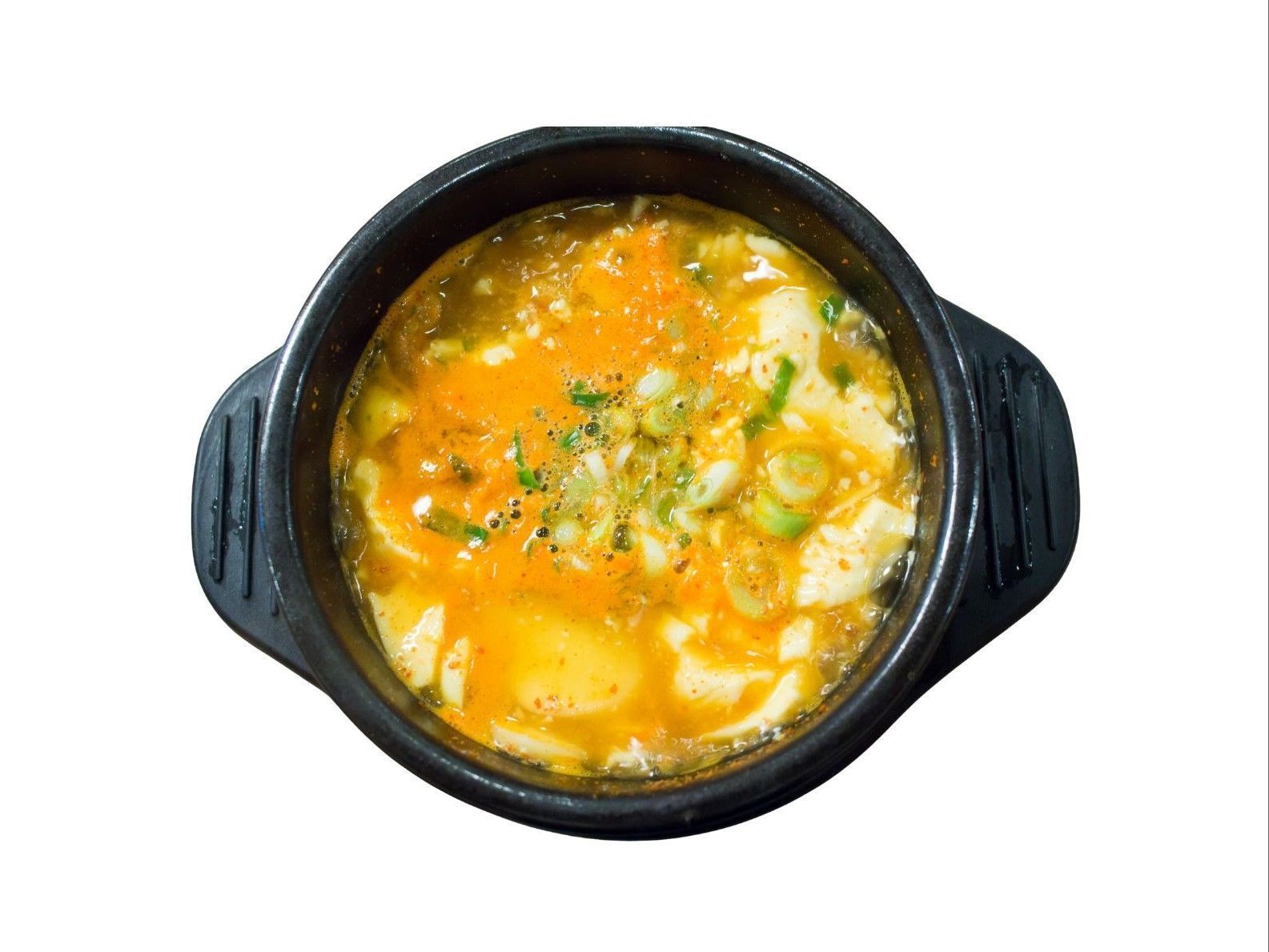 Grilled chicken salad in a silver tray.  Chicken is sliced and drizzled with sauce, resting on a bed of lettuce and shredded vegetables.