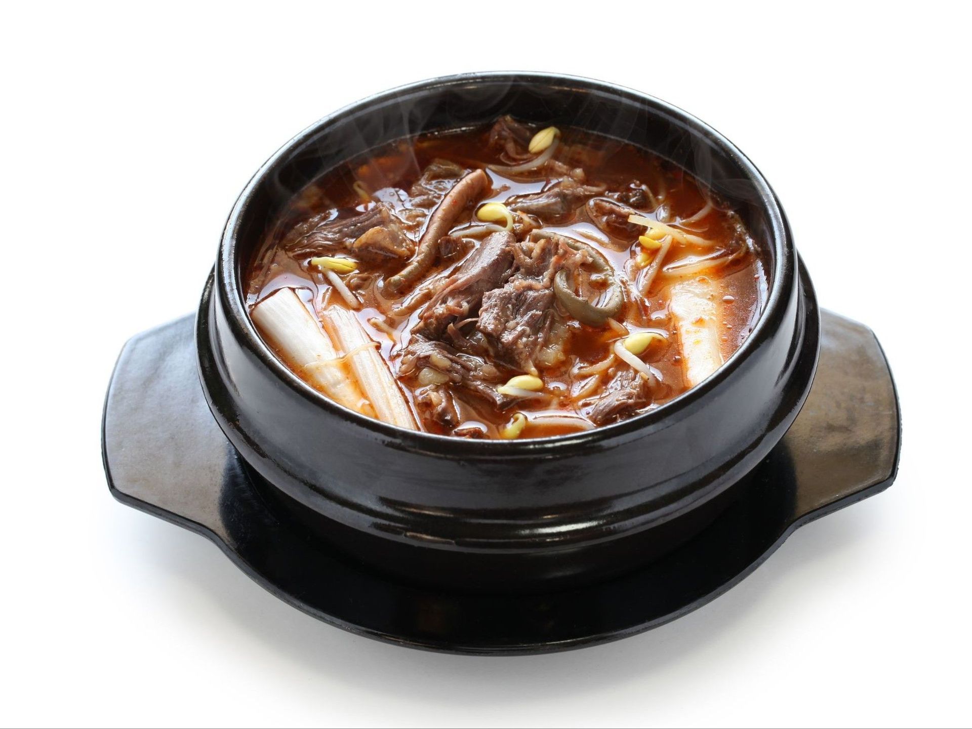 Chicken salad on a tray with lettuce, shredded carrots, and cabbage. Chicken is drizzled with a dark sauce.