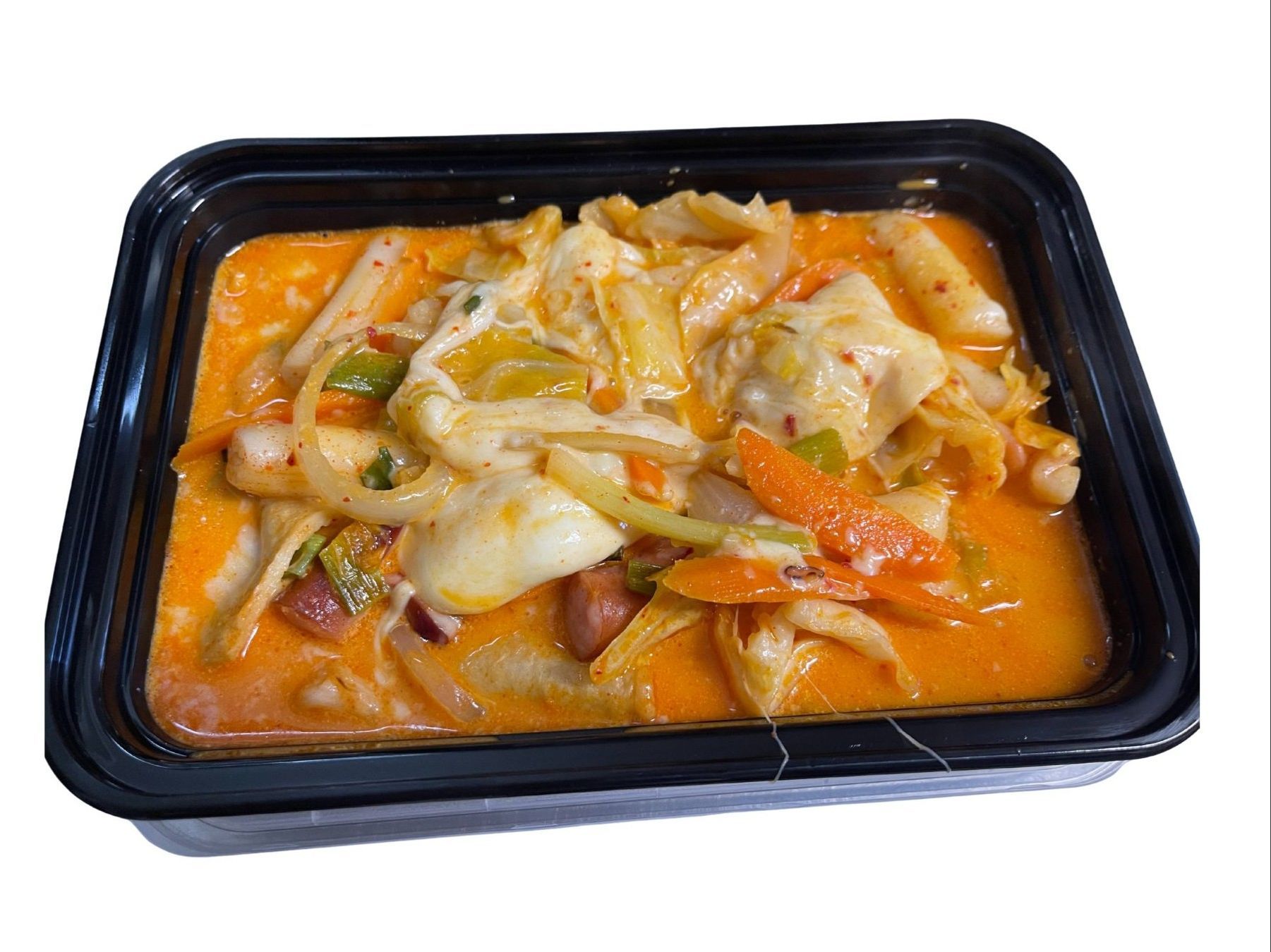 Korean fried chicken in red sauce and shredded cabbage on a silver tray.