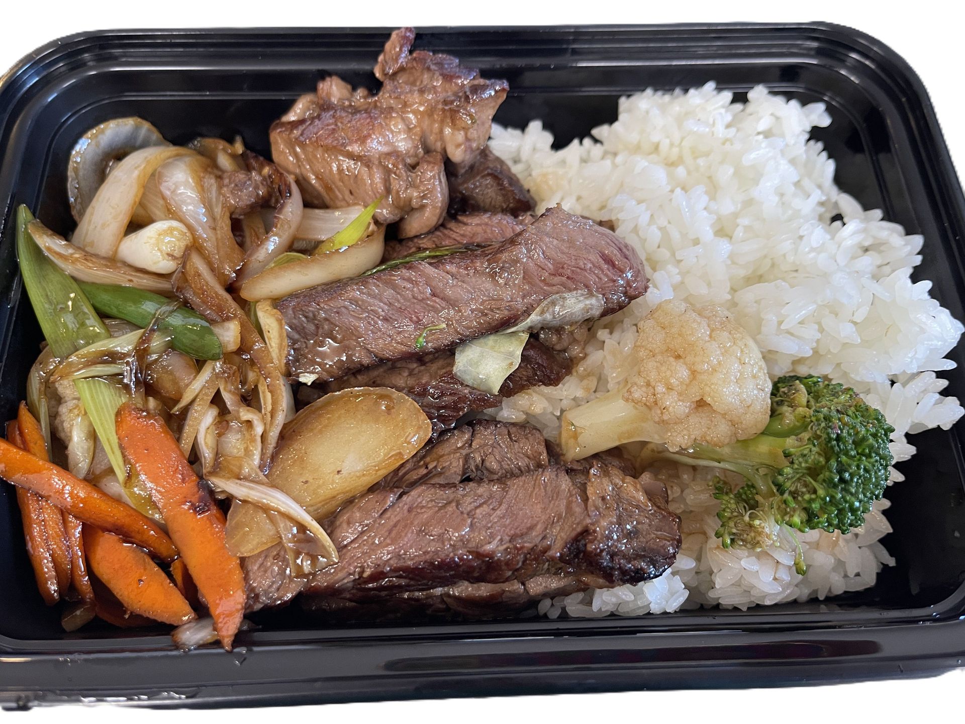 Chicken salad with dressing on a bed of greens and shredded vegetables, served on a silver tray.