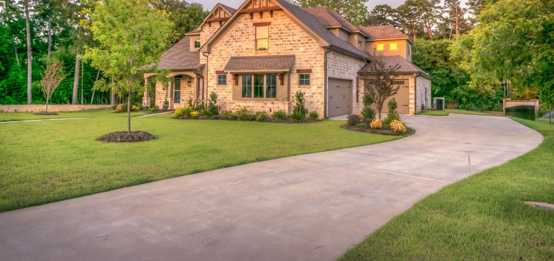 A large house with a long driveway leading to it.