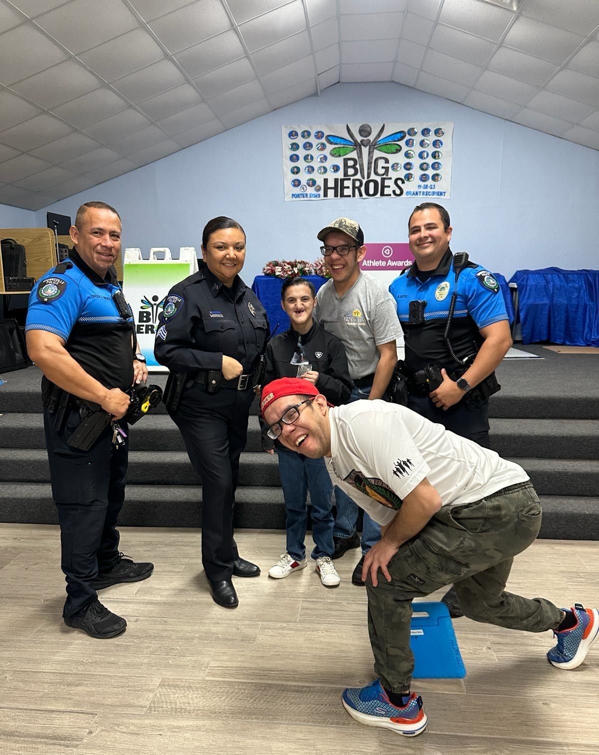 A group of police officers and a man are posing for a picture.