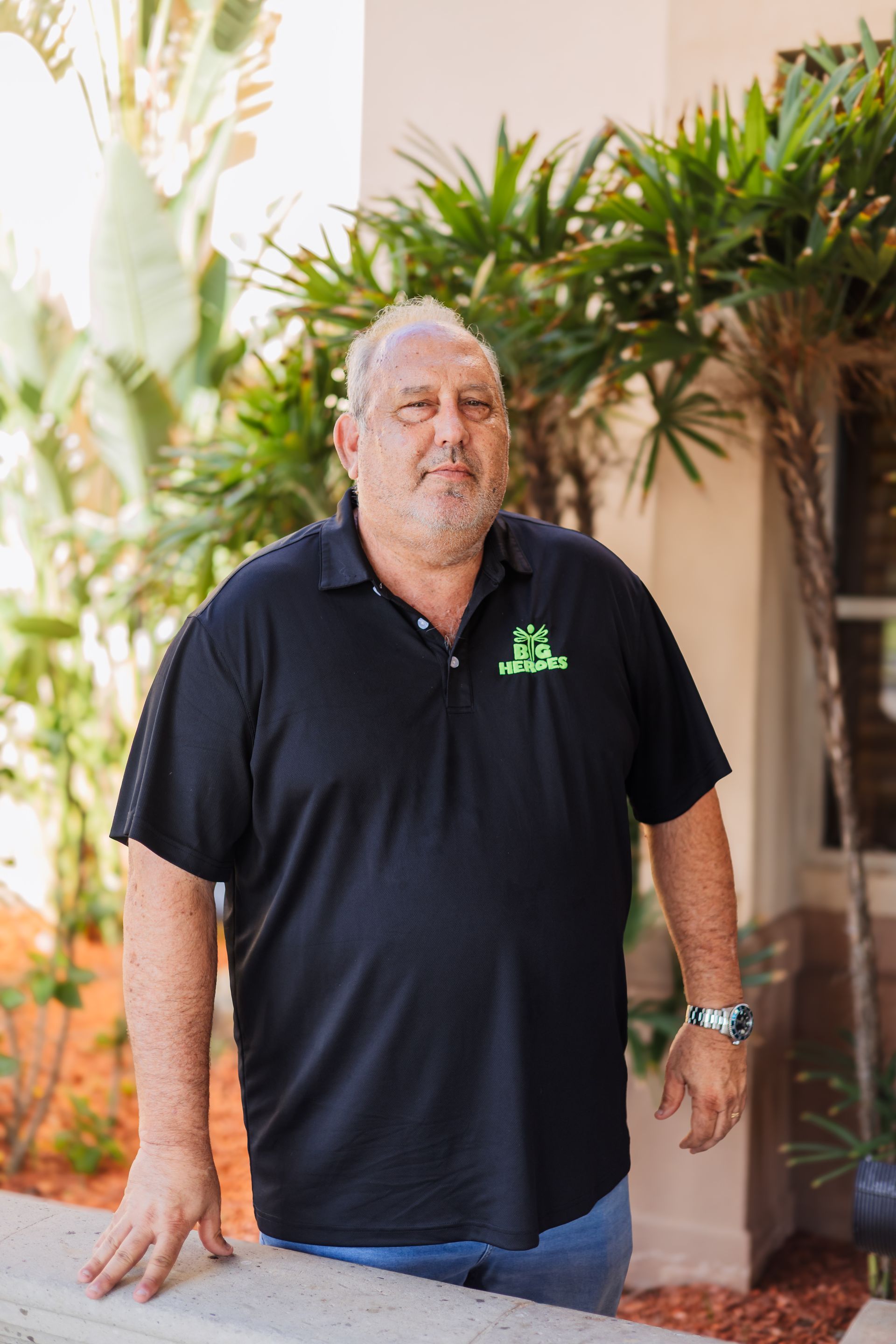 A man wearing a black shirt with the word rescue on it