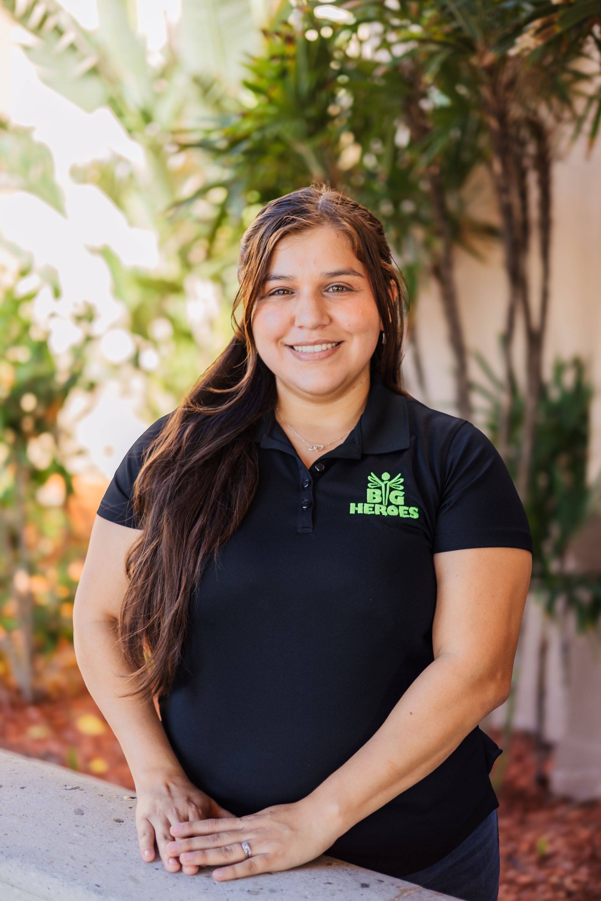 A woman wearing a black shirt that says big heroes