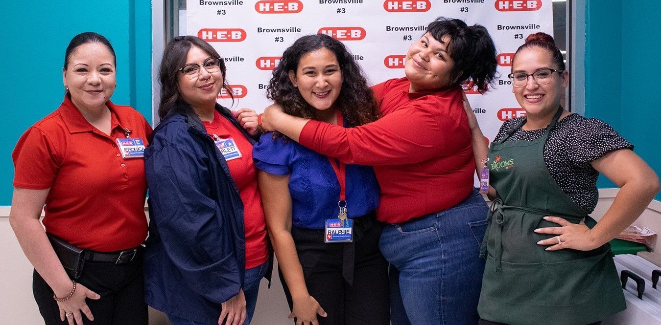 A group of women are posing for a picture together.