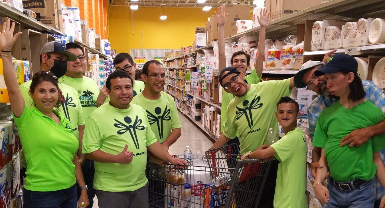 A group of people are posing for a picture in a grocery store.