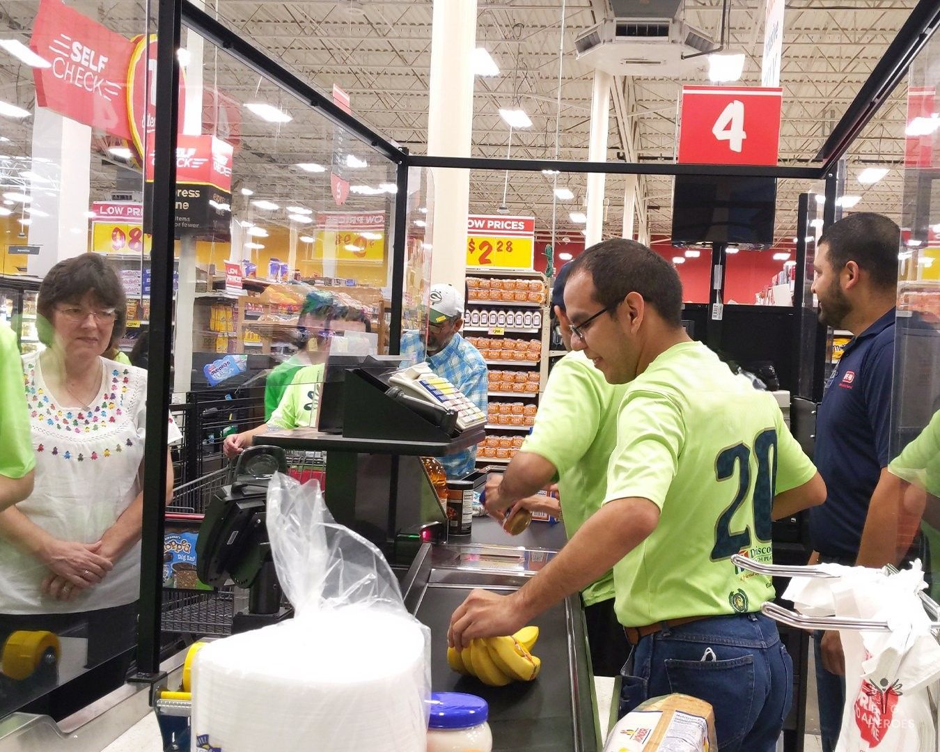 A man wearing a green shirt with the number 20 on it