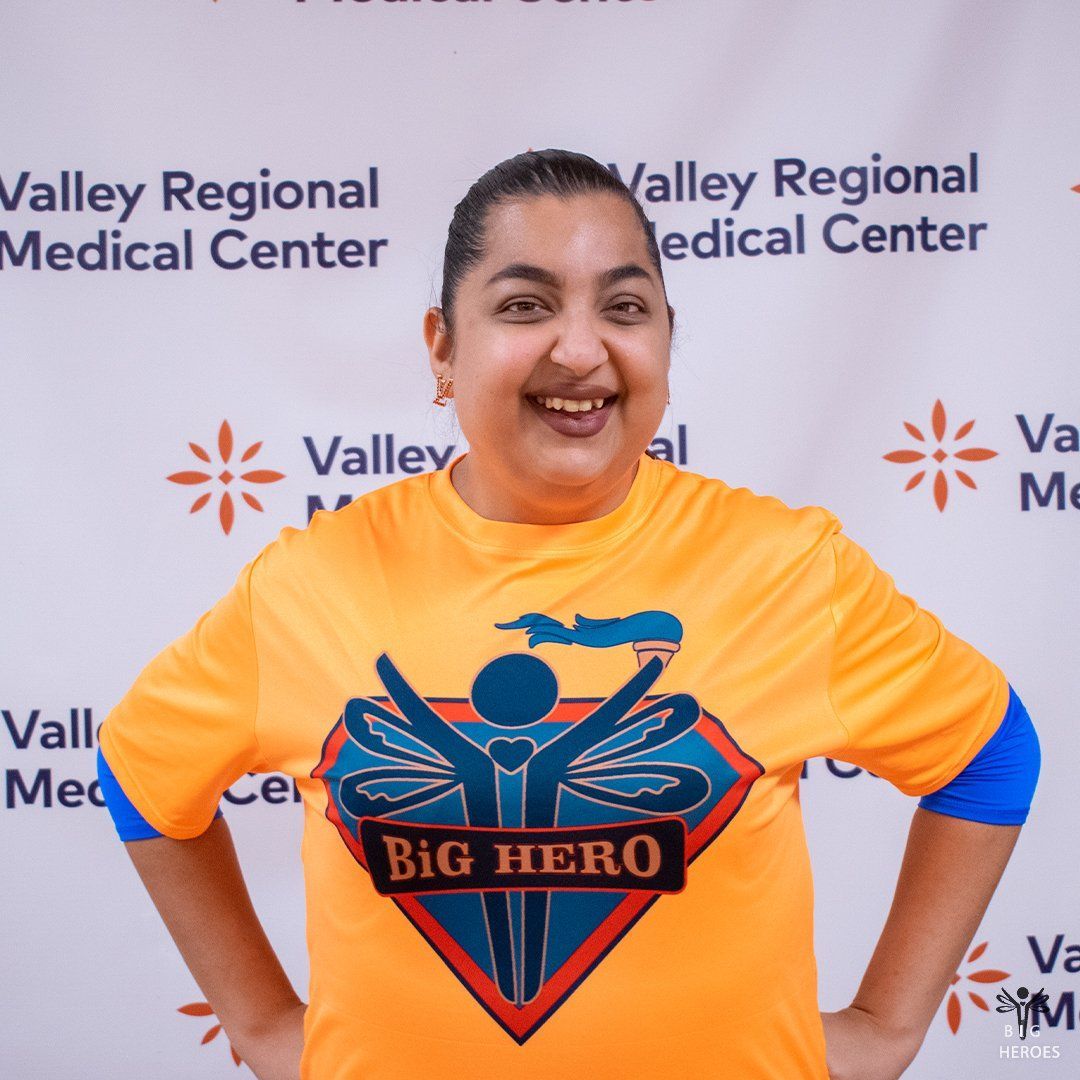 A woman wearing an orange shirt that says big hero