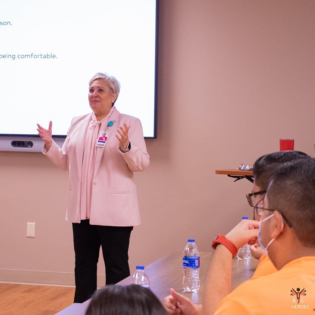 A woman is giving a presentation to a group of people