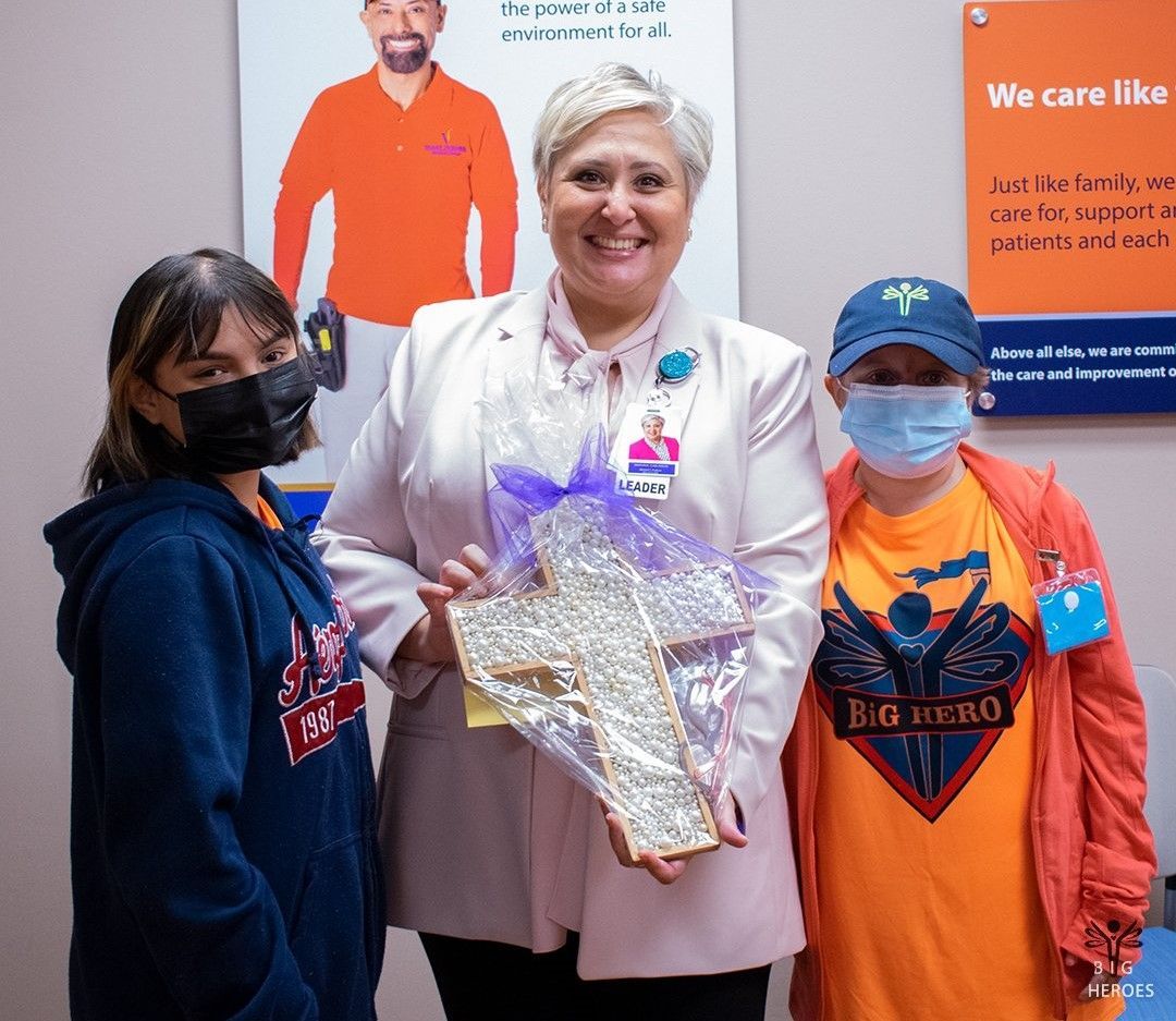 A group of people wearing masks are posing for a picture.