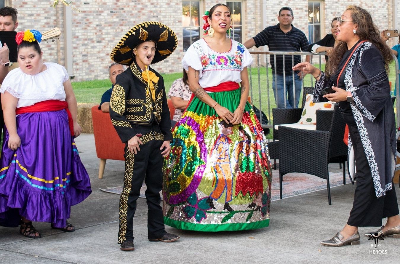 A group of people dressed in traditional mexican clothing are standing next to each other.