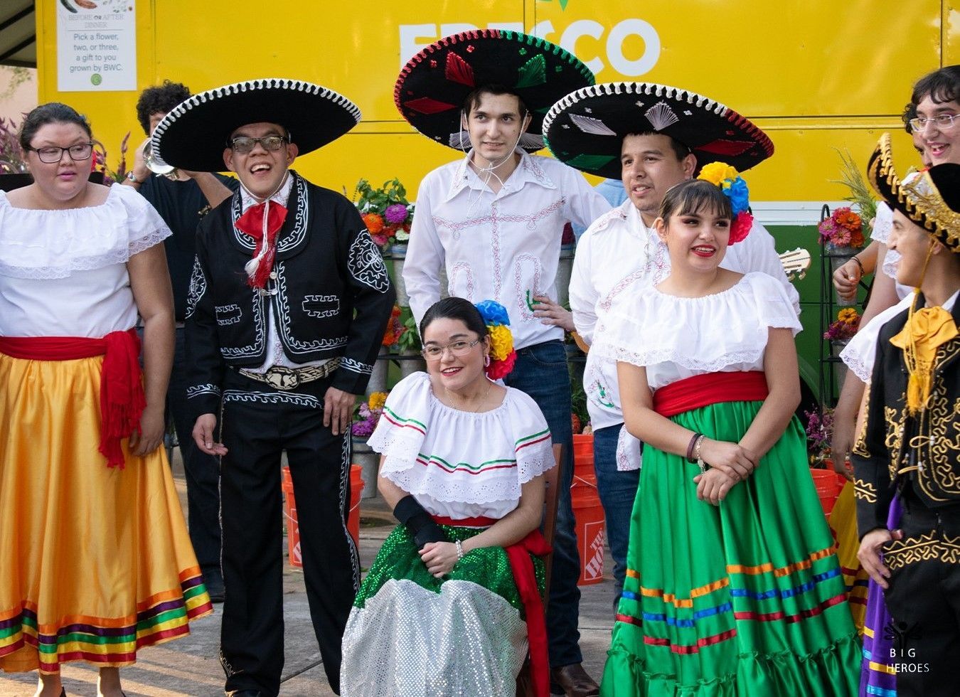 A group of people dressed in traditional mexican costumes are posing for a picture