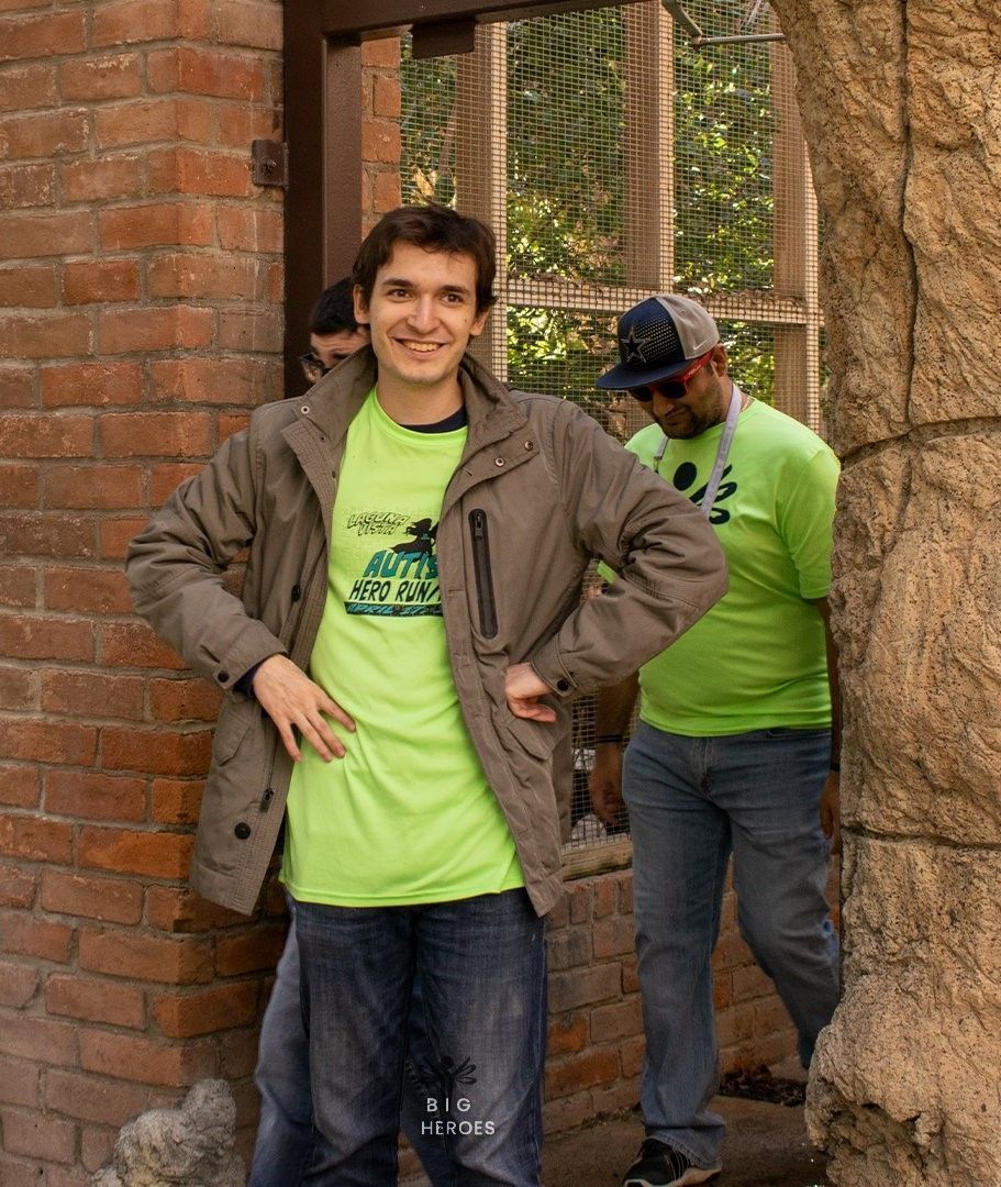 A man wearing a green shirt with a motorcycle on it
