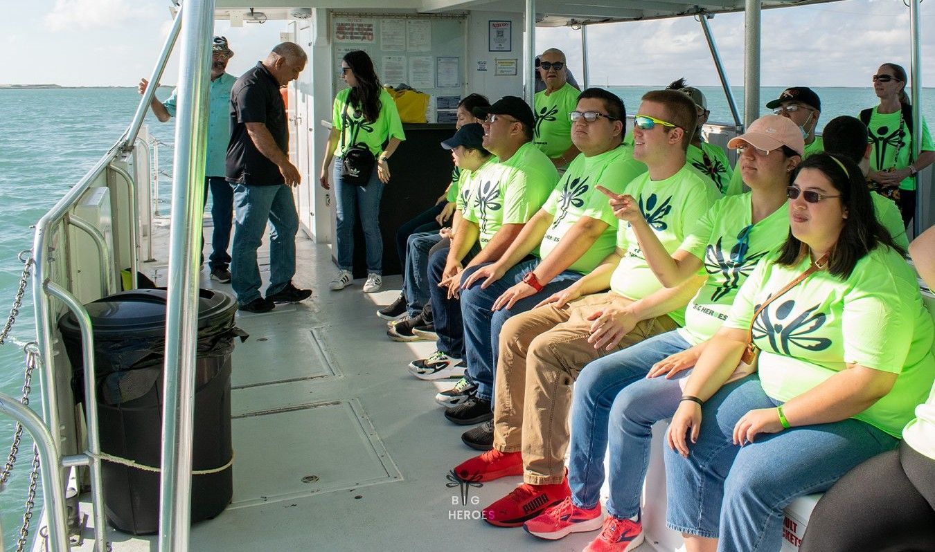 A group of people are sitting on a boat in the ocean.