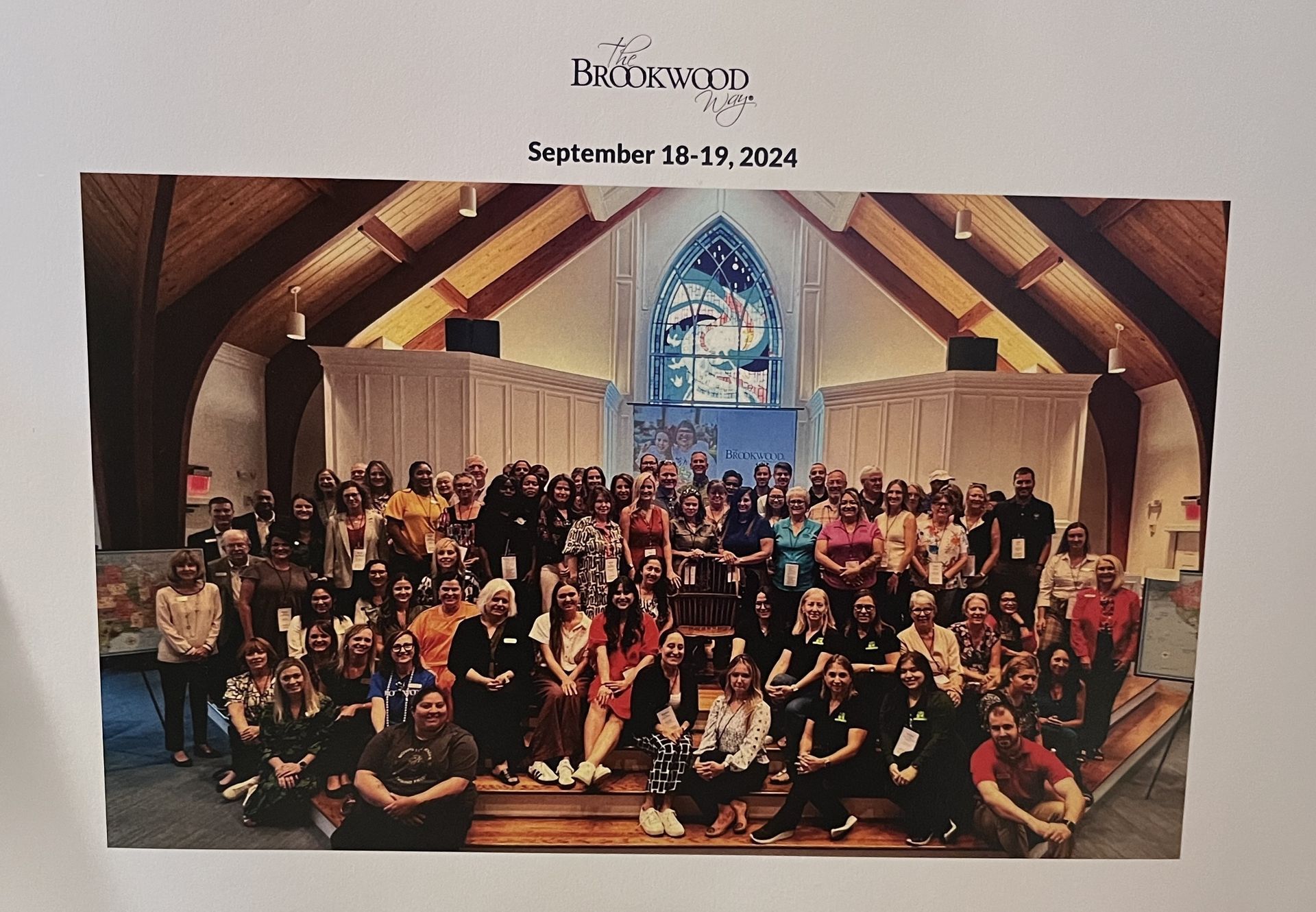 A large group of people are posing for a picture in a church