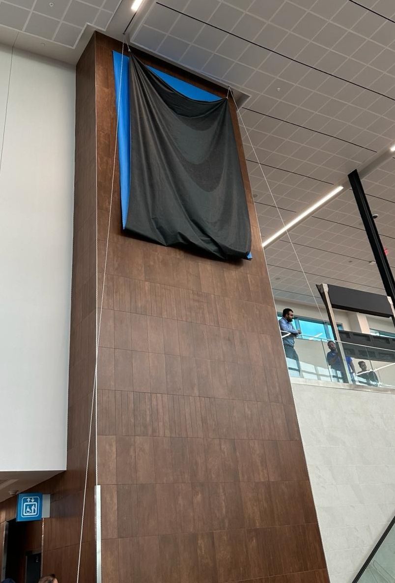 A large wooden wall with a black cloth on it