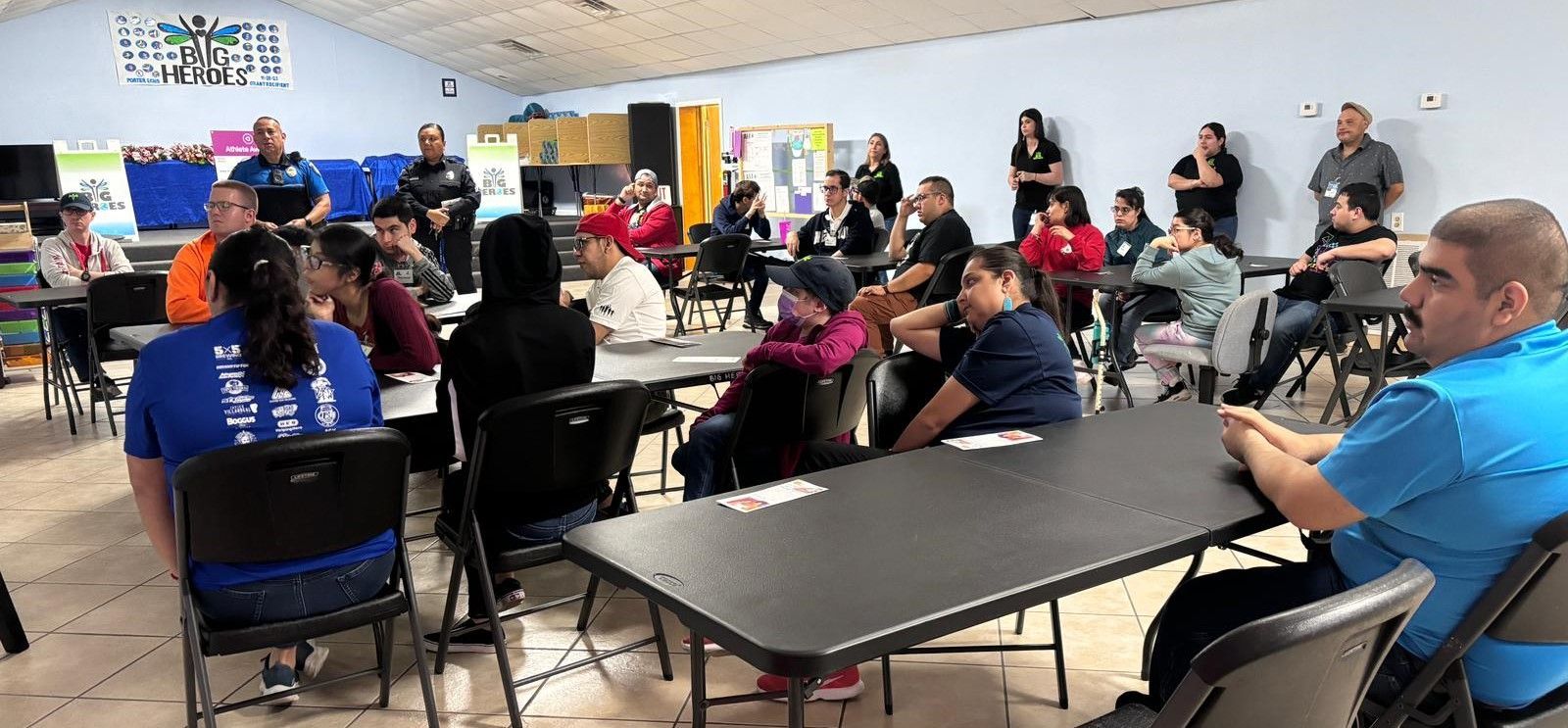 A group of people are sitting at tables in a room.
