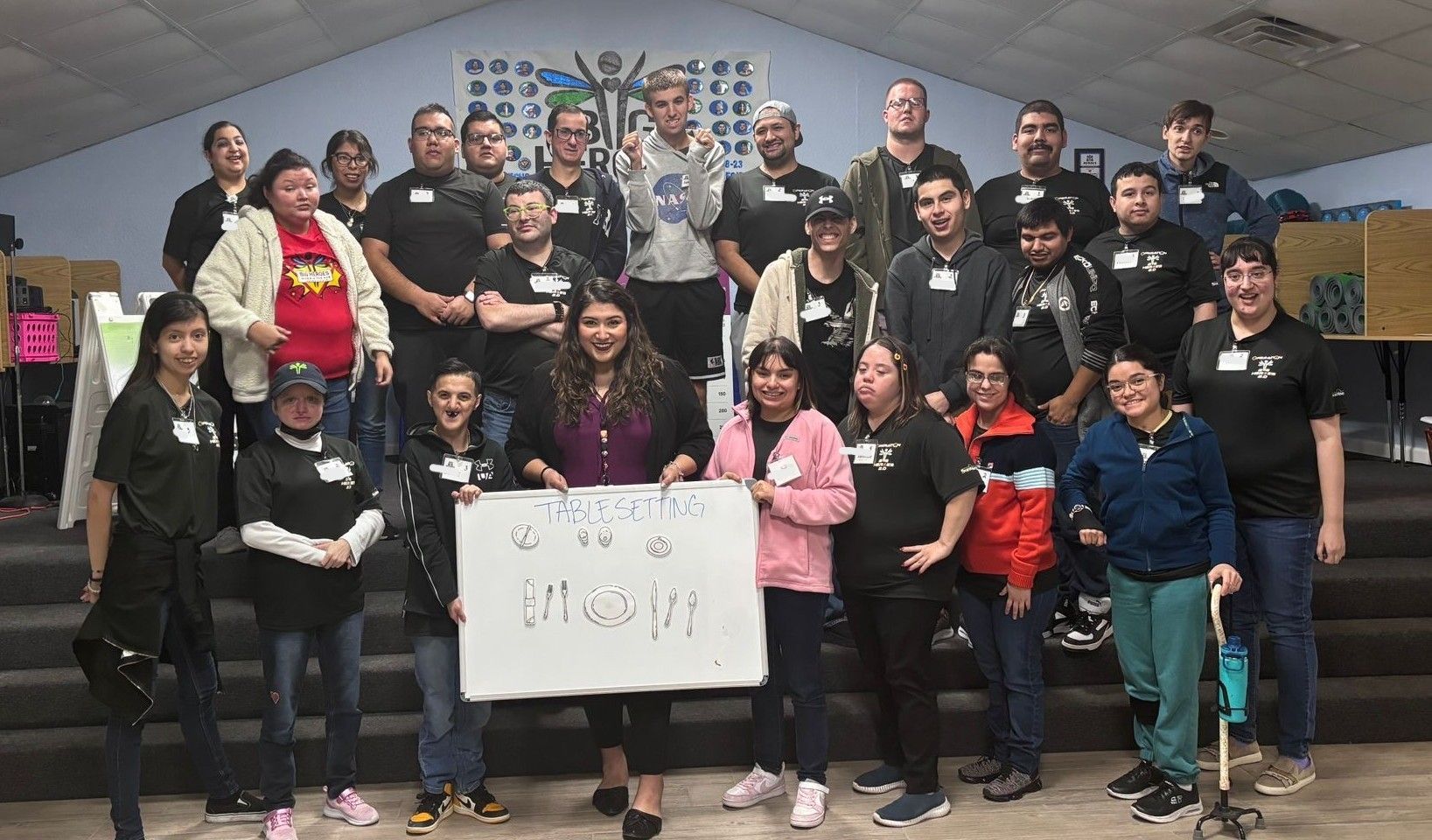 A group of people are posing for a picture in a room.