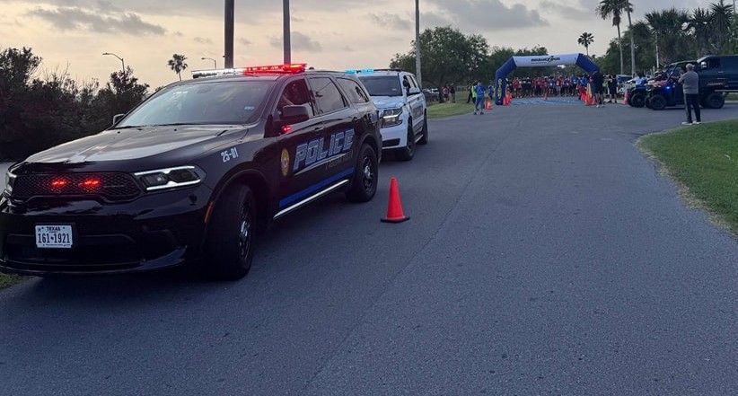 A police car is parked on the side of the road.