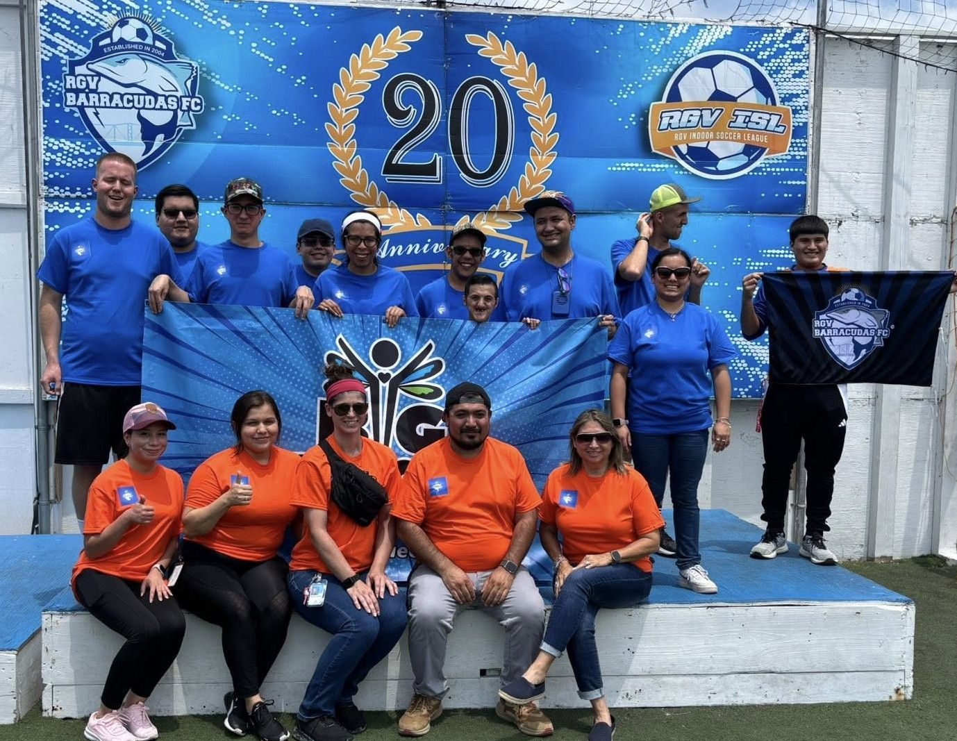 A group of people standing in front of a sign that says 20