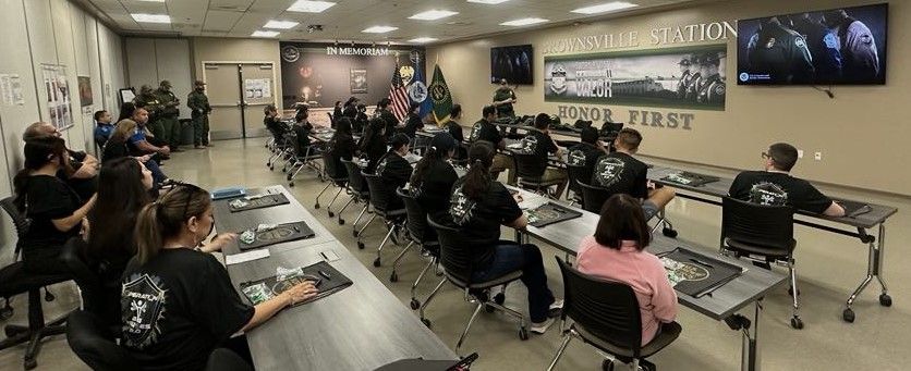 A group of people are sitting at tables in a room.