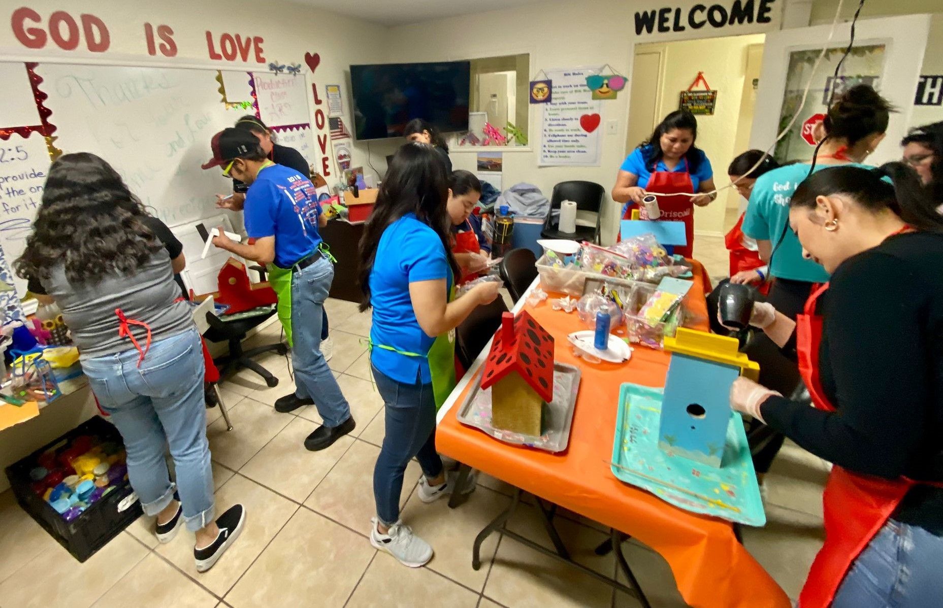 A group of people are working on a project in a room.