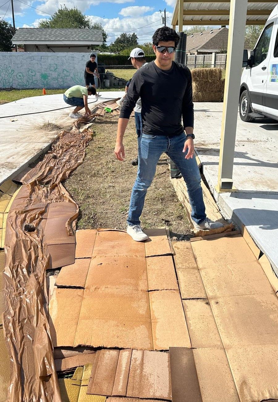 A man is standing on a pile of cardboard boxes.