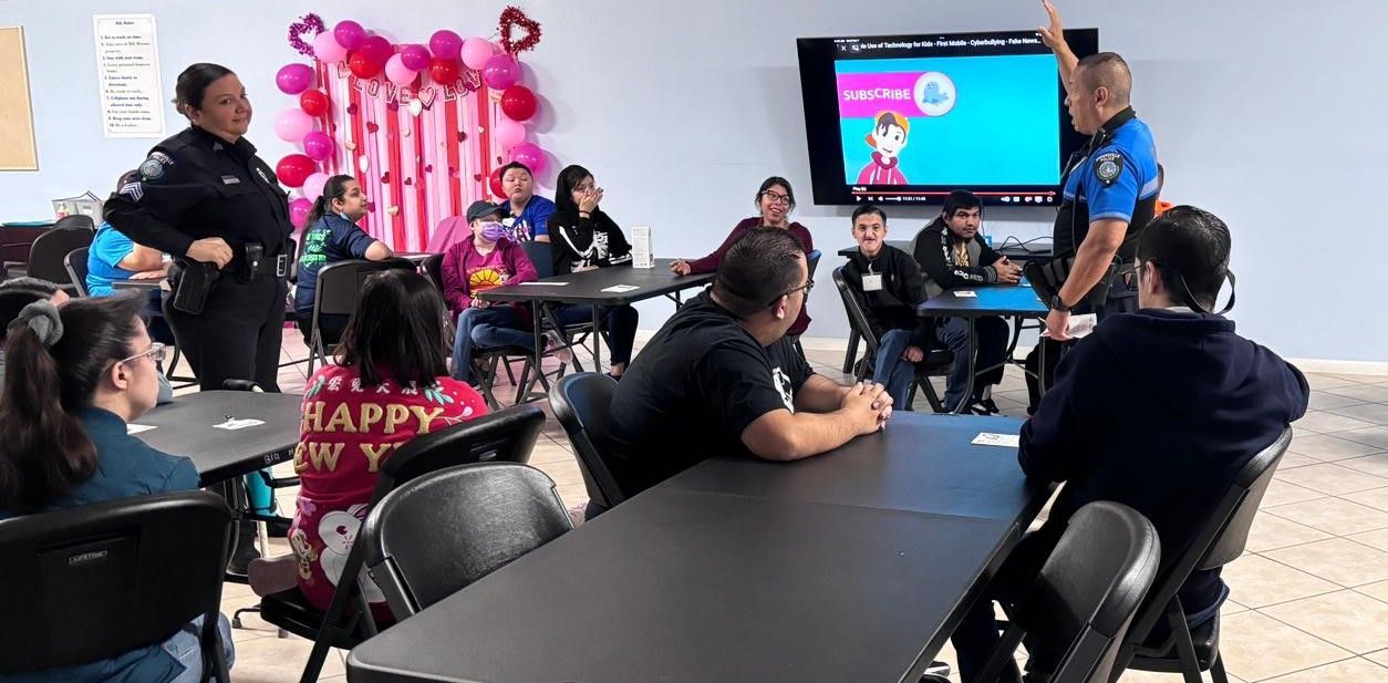A group of people are sitting at tables in a room.