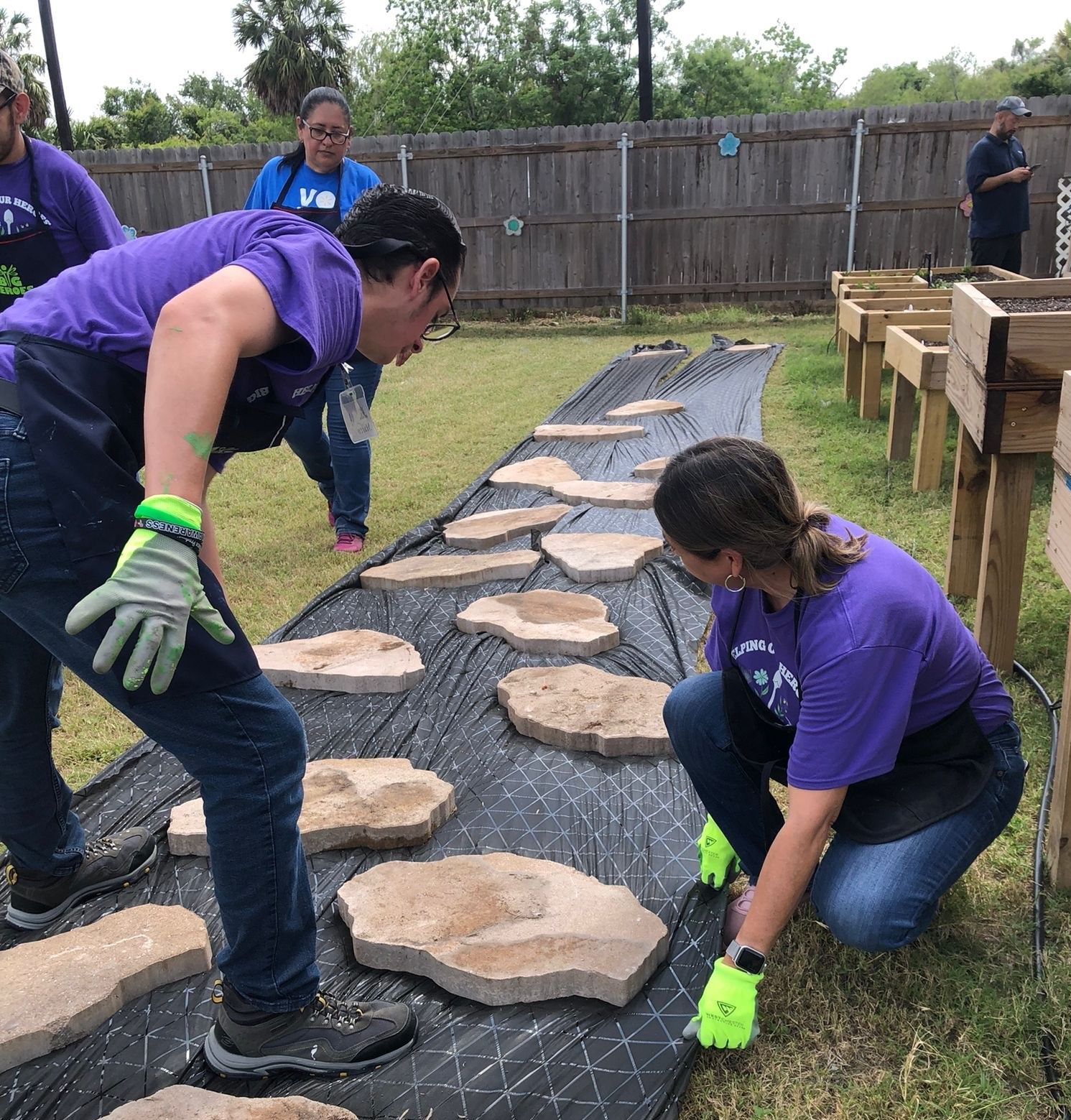 A group of people are working on a walkway made of rocks