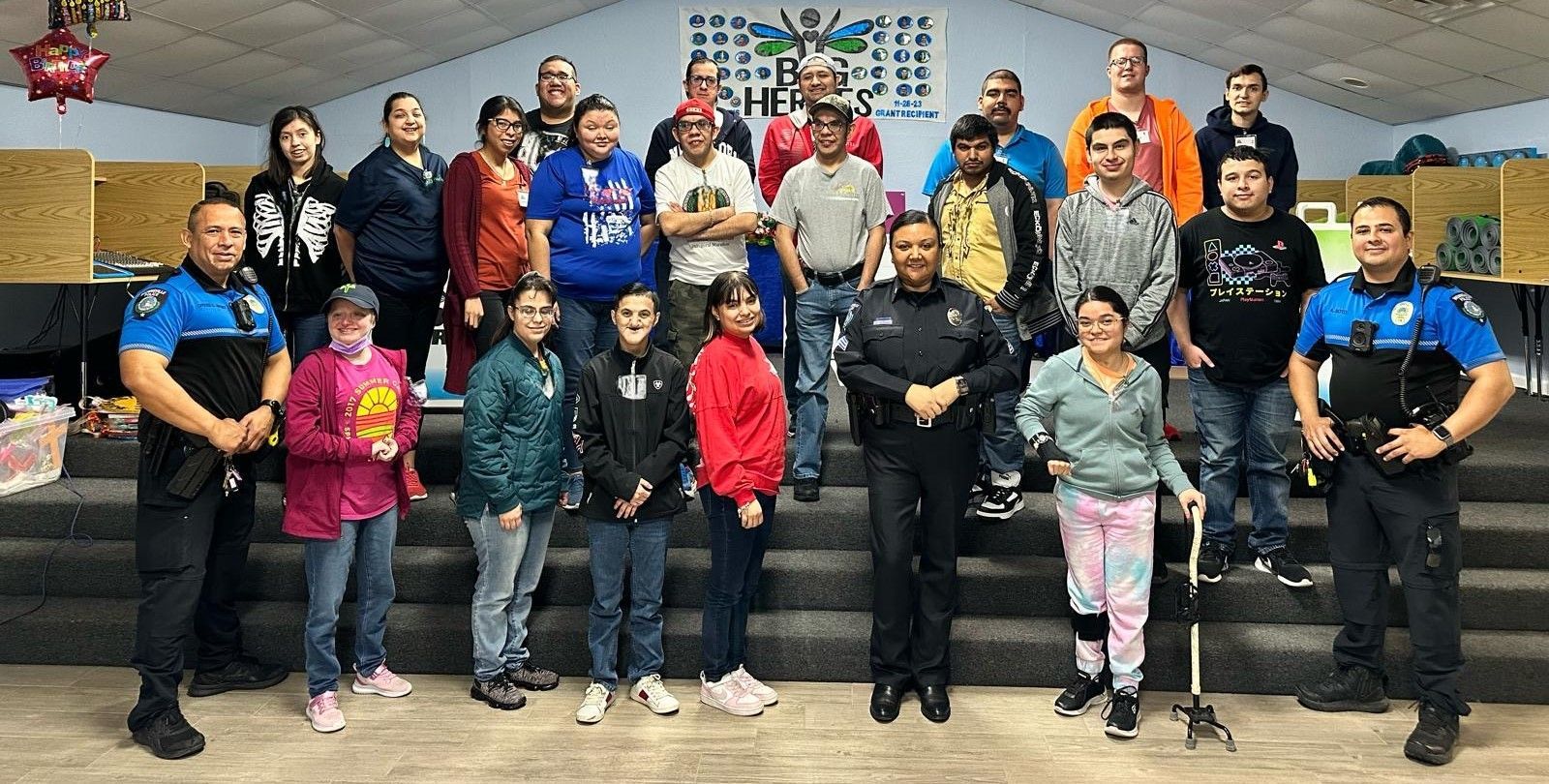 A group of people and police officers are posing for a picture.