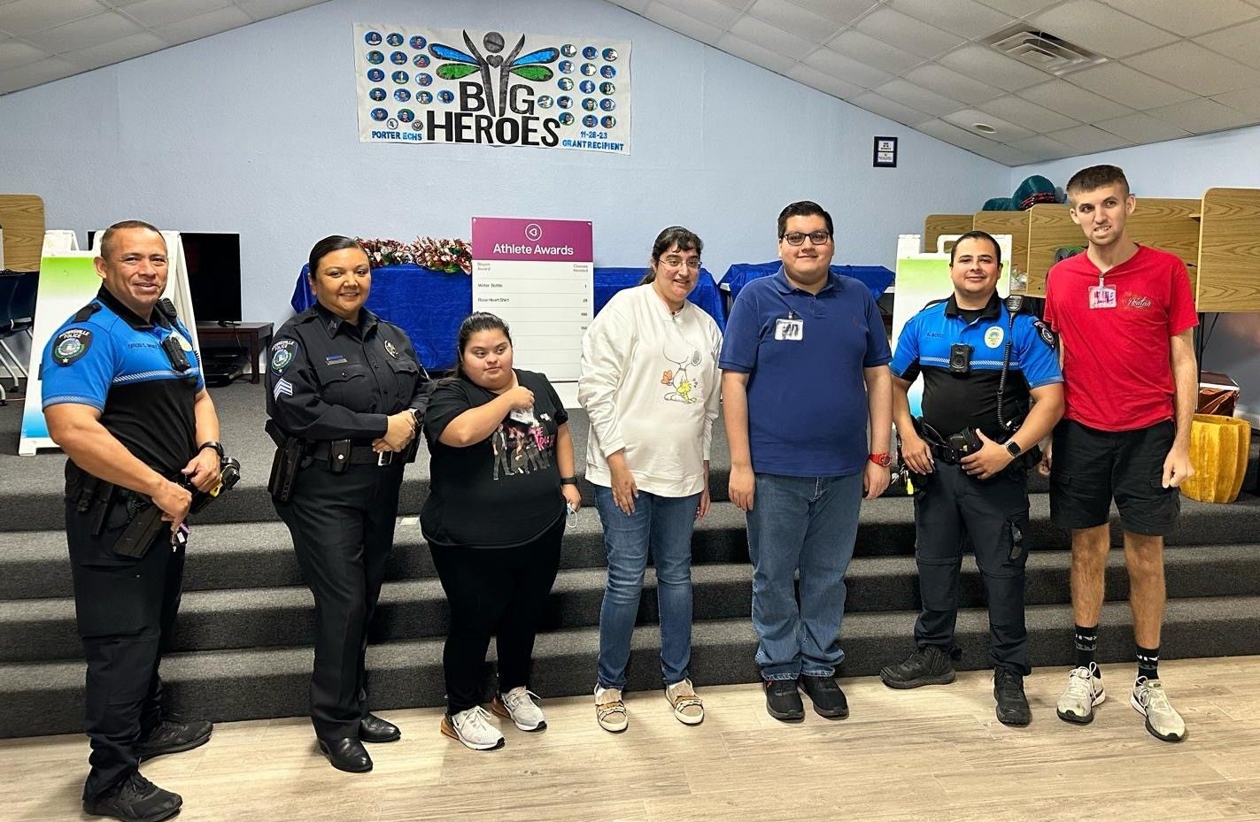 A group of people standing next to each other in a room.