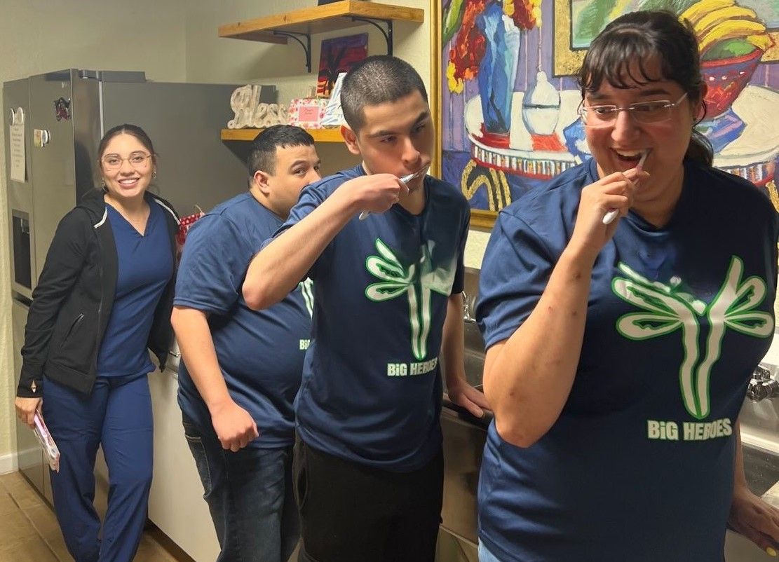 A group of people wearing blue shirts with dragonflies on them
