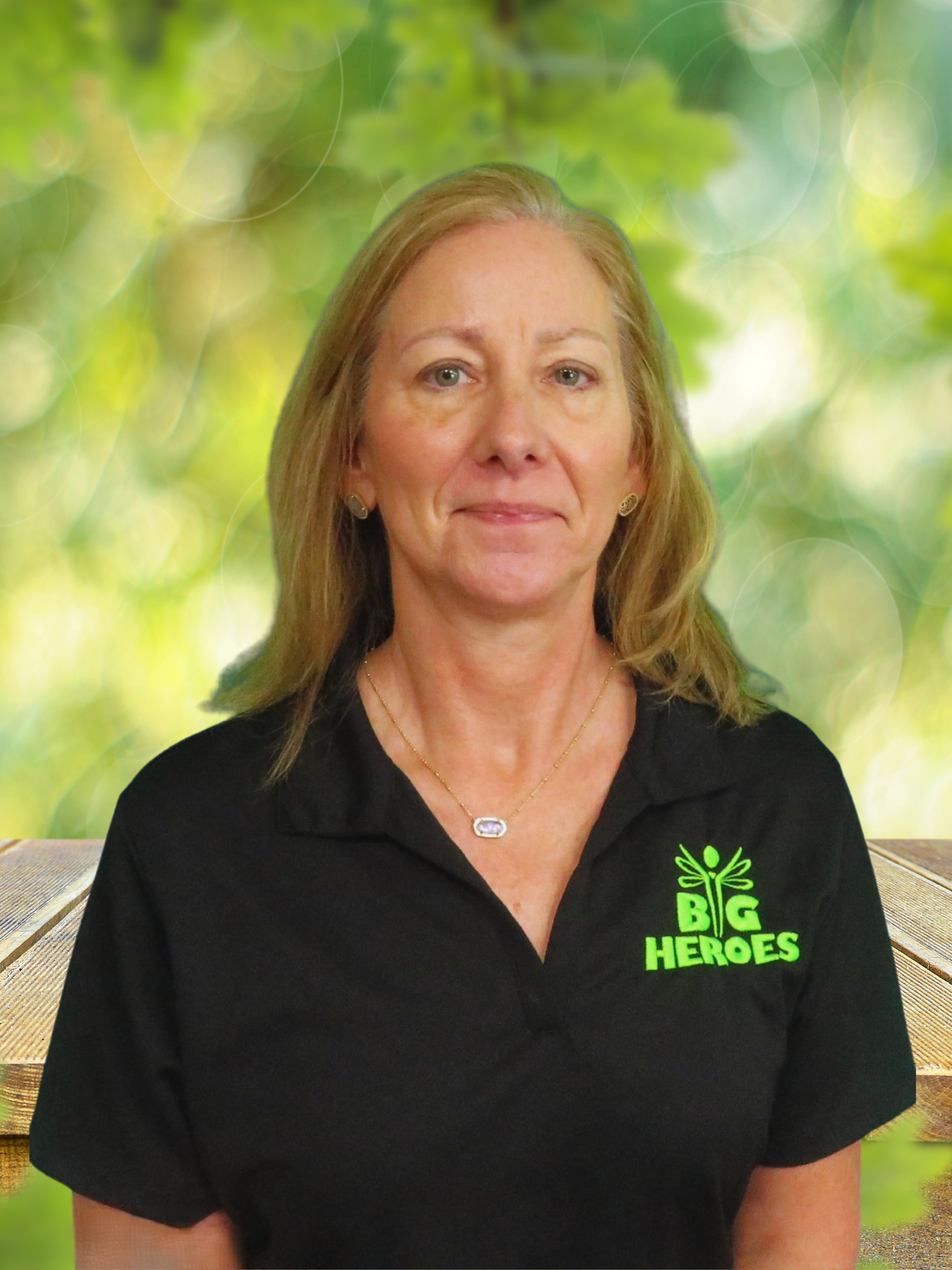 A woman wearing a black shirt that says big heroes