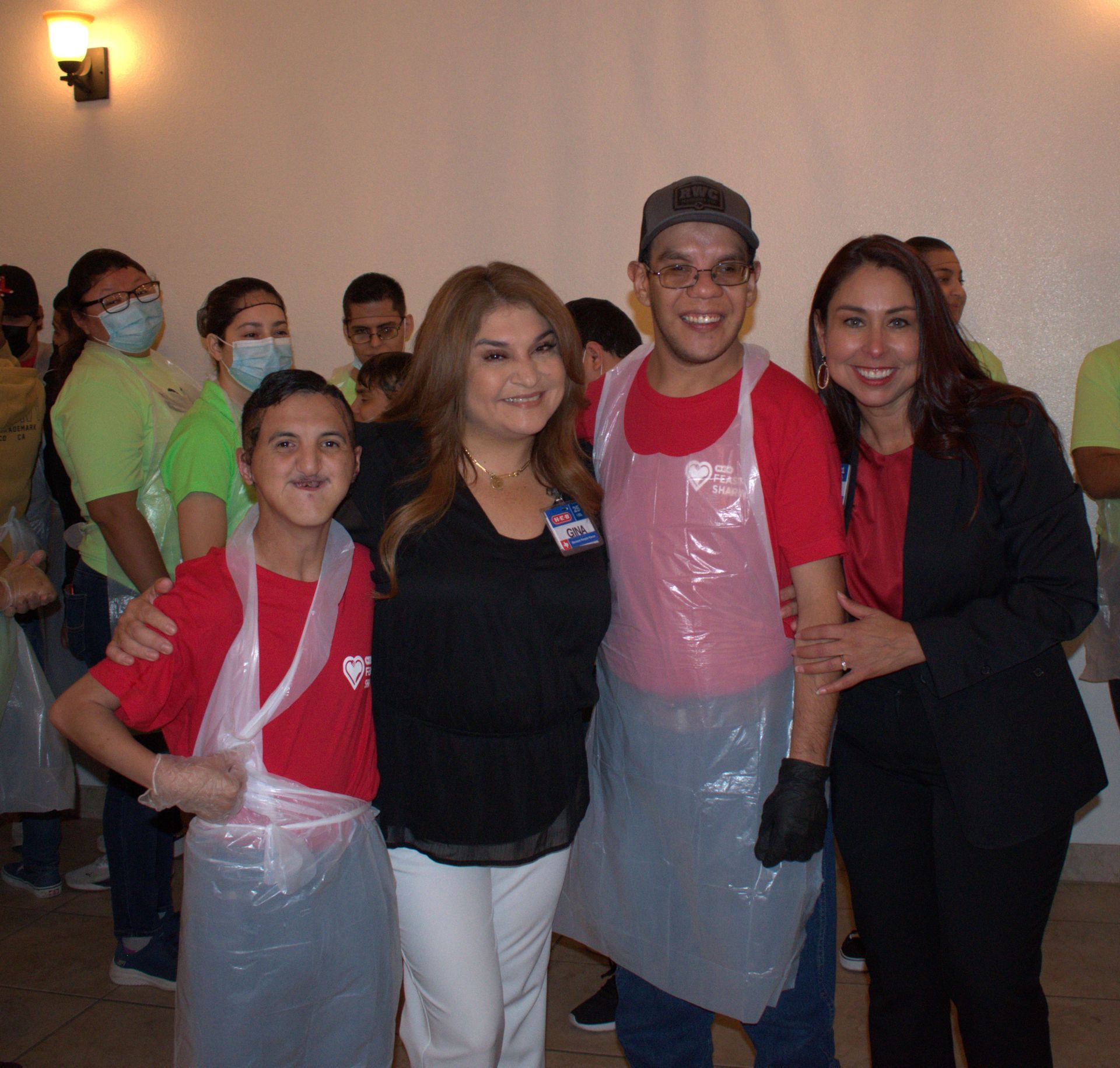 A group of people posing for a picture with one wearing a name tag