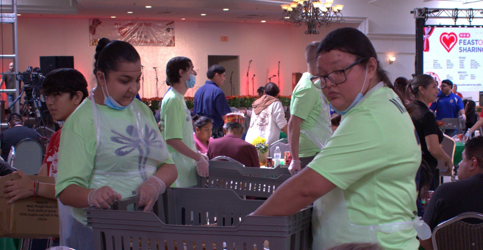 A group of people are standing around a table in a room.