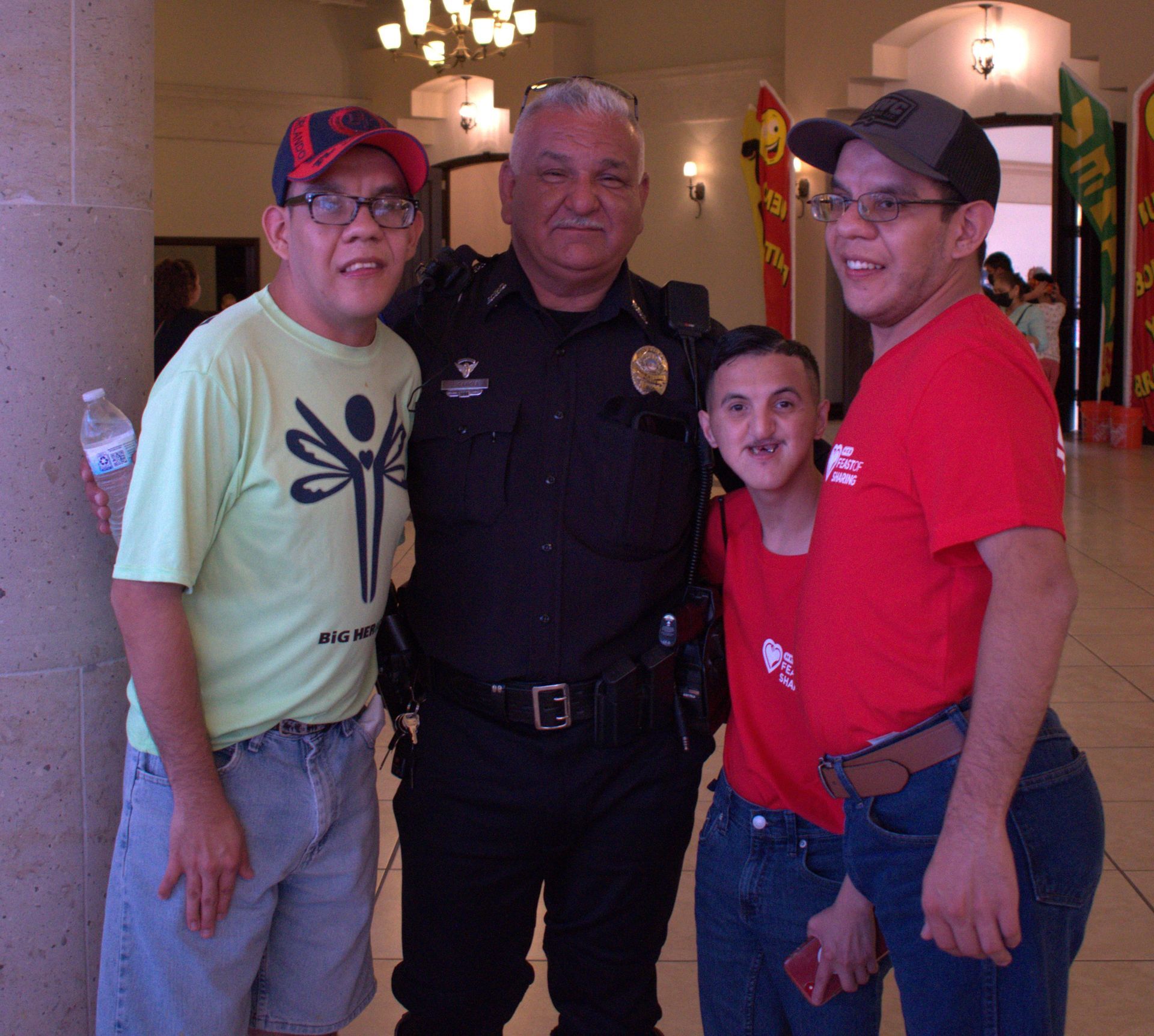 A group of people posing for a picture including a police officer