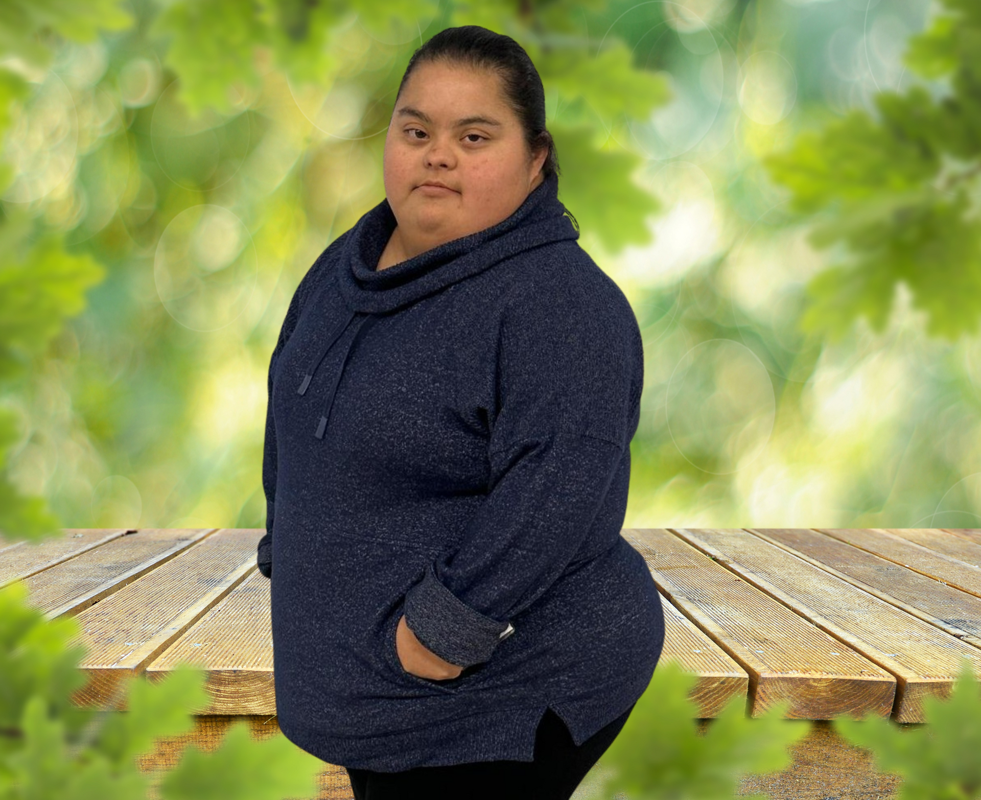 A woman in a blue sweater is standing on a wooden table.