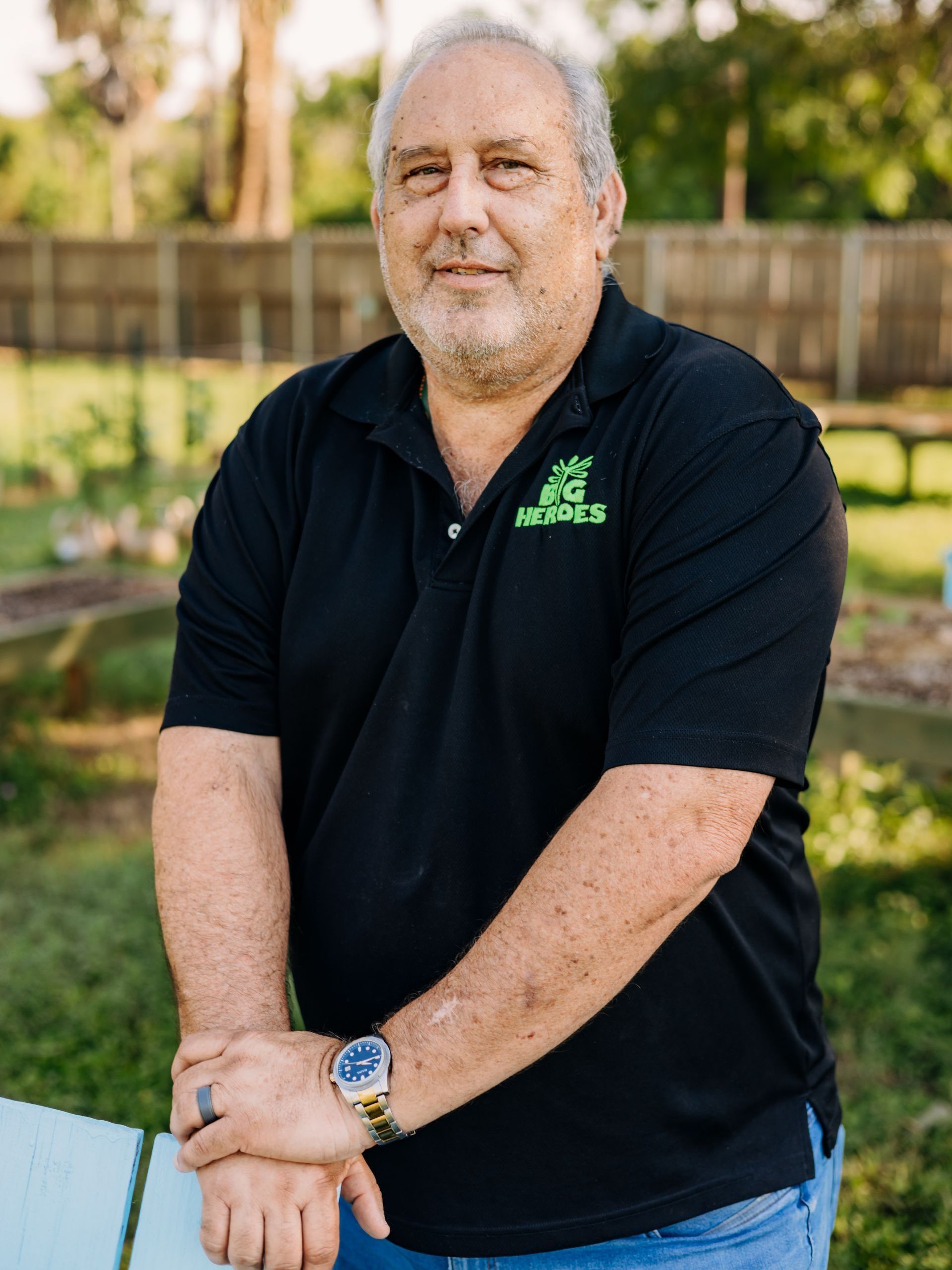 A man wearing a black shirt with the word rescue on it