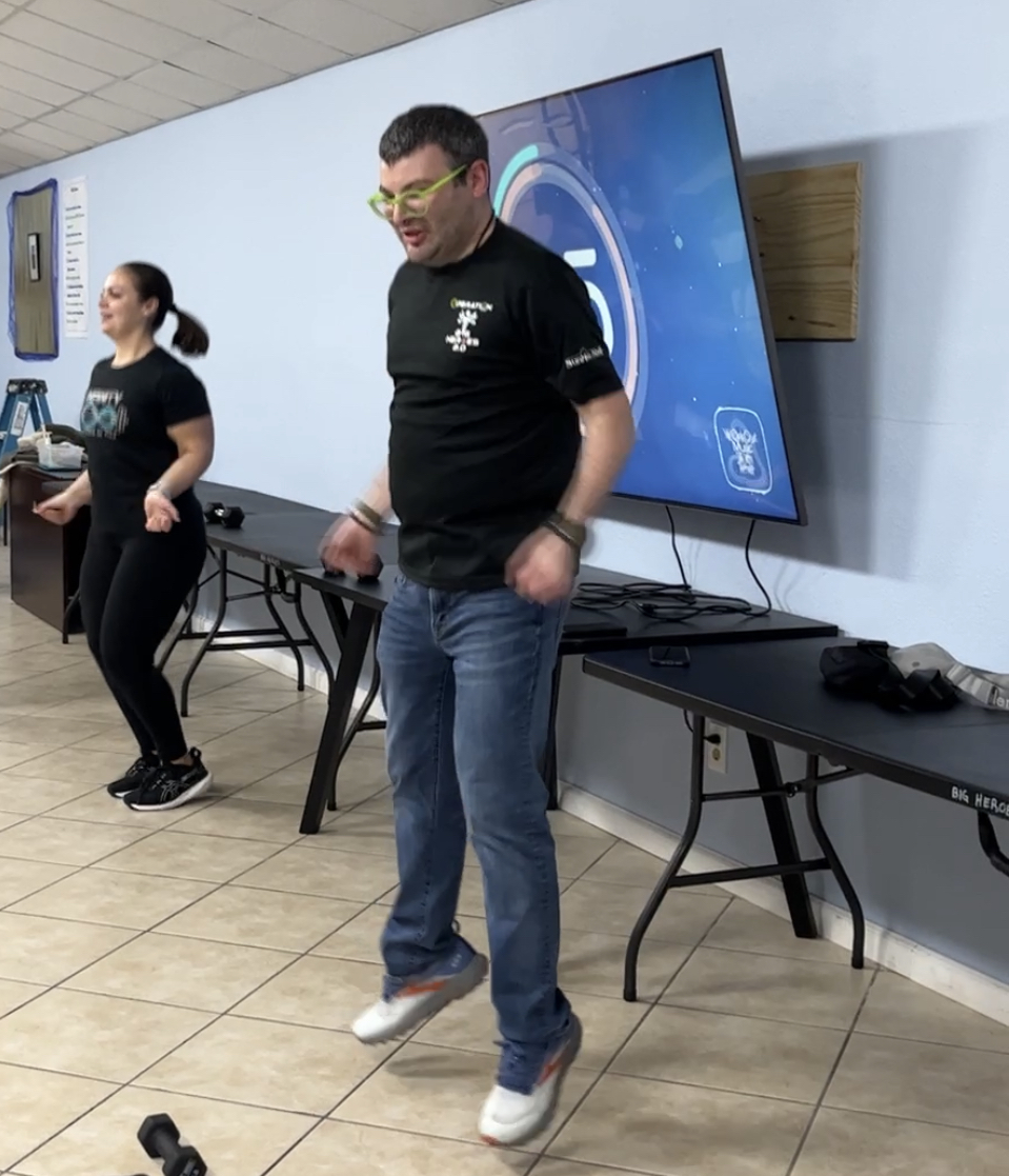 A man and a woman are dancing in a room