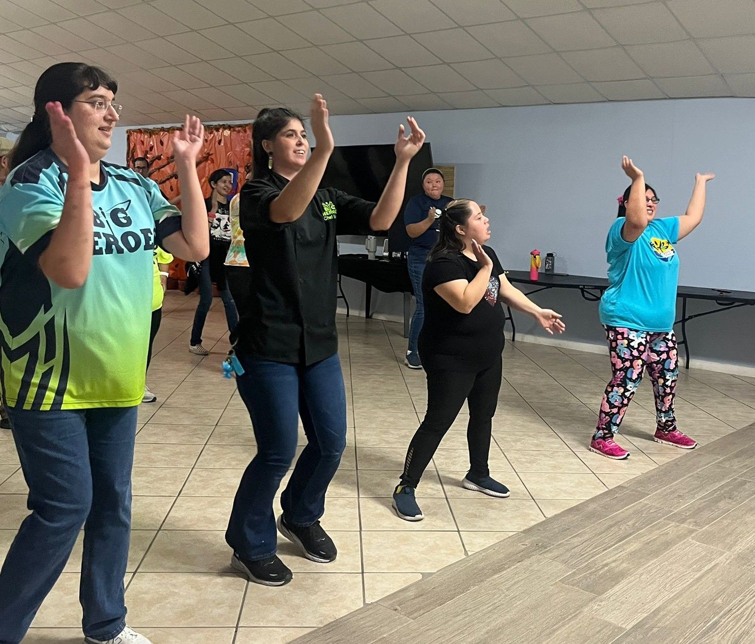 A group of women are dancing together in a room.
