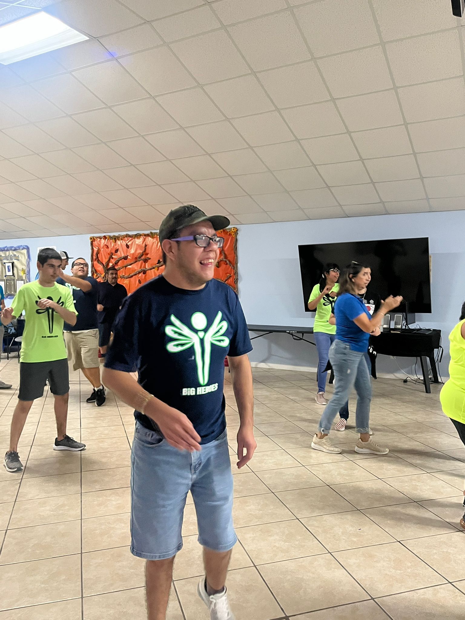 A group of people are dancing in a room.