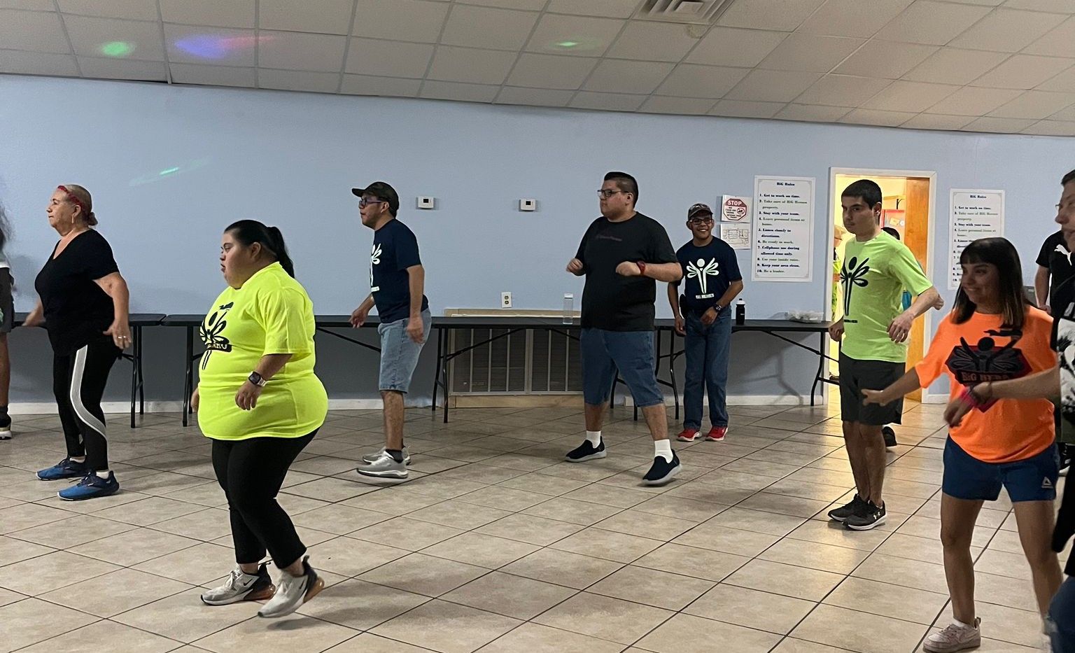 A group of people are dancing in a room.