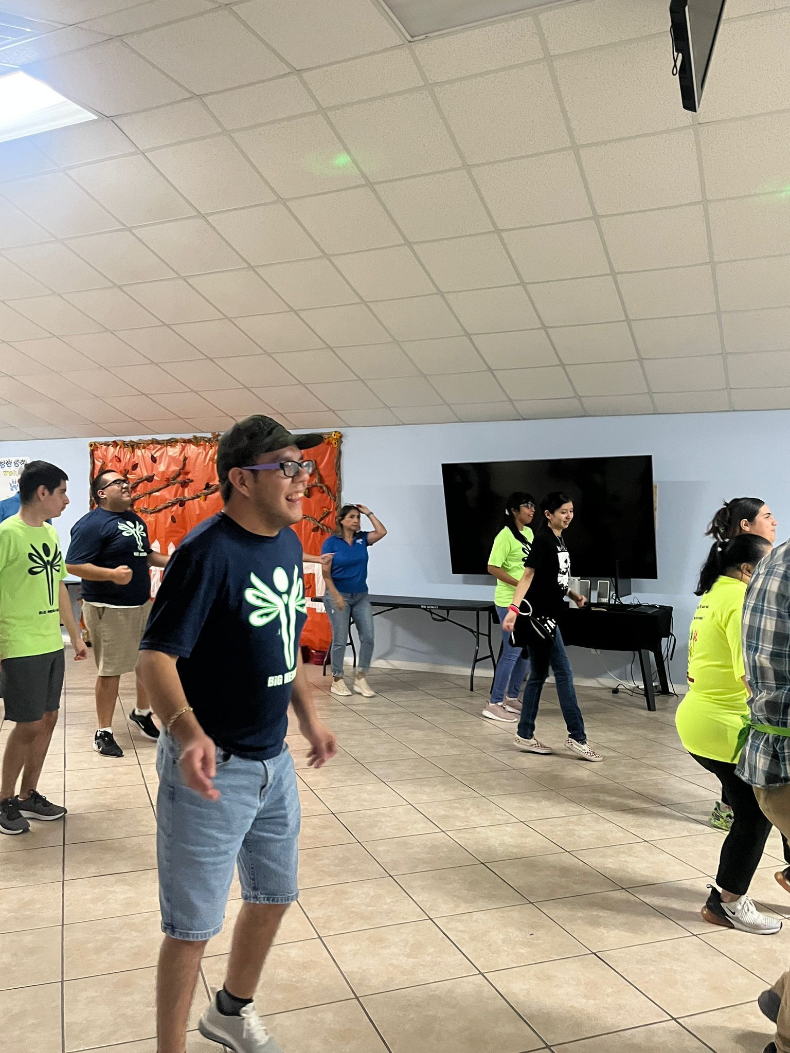 A group of people are dancing in a room.
