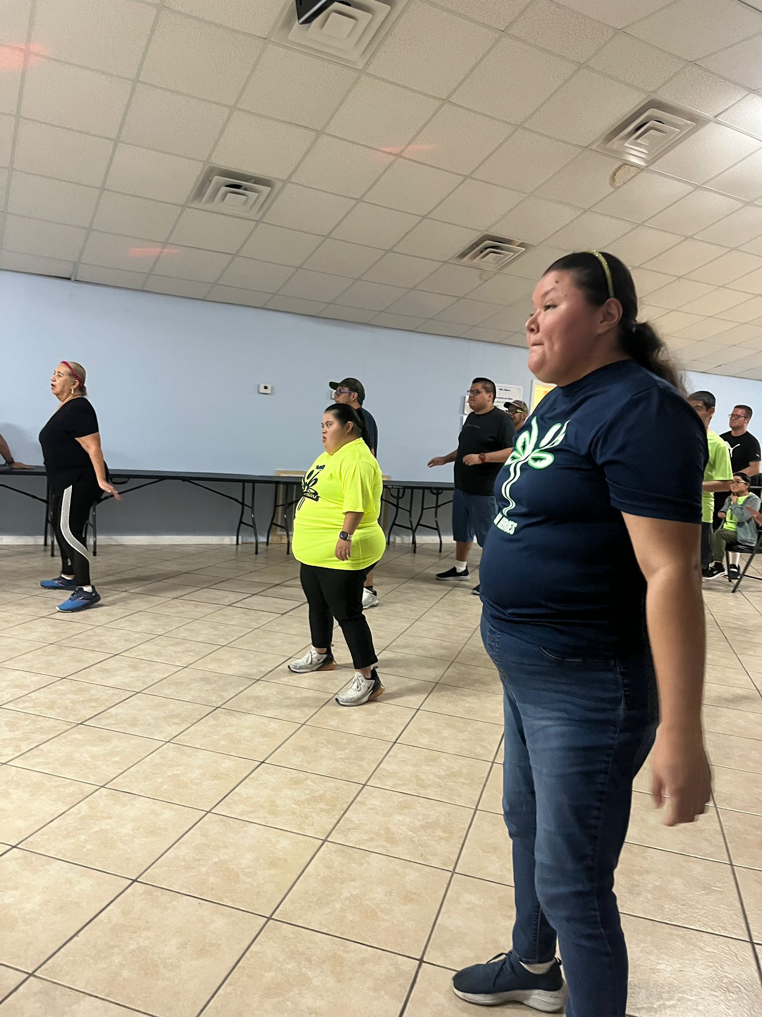 A group of people are standing in a room.