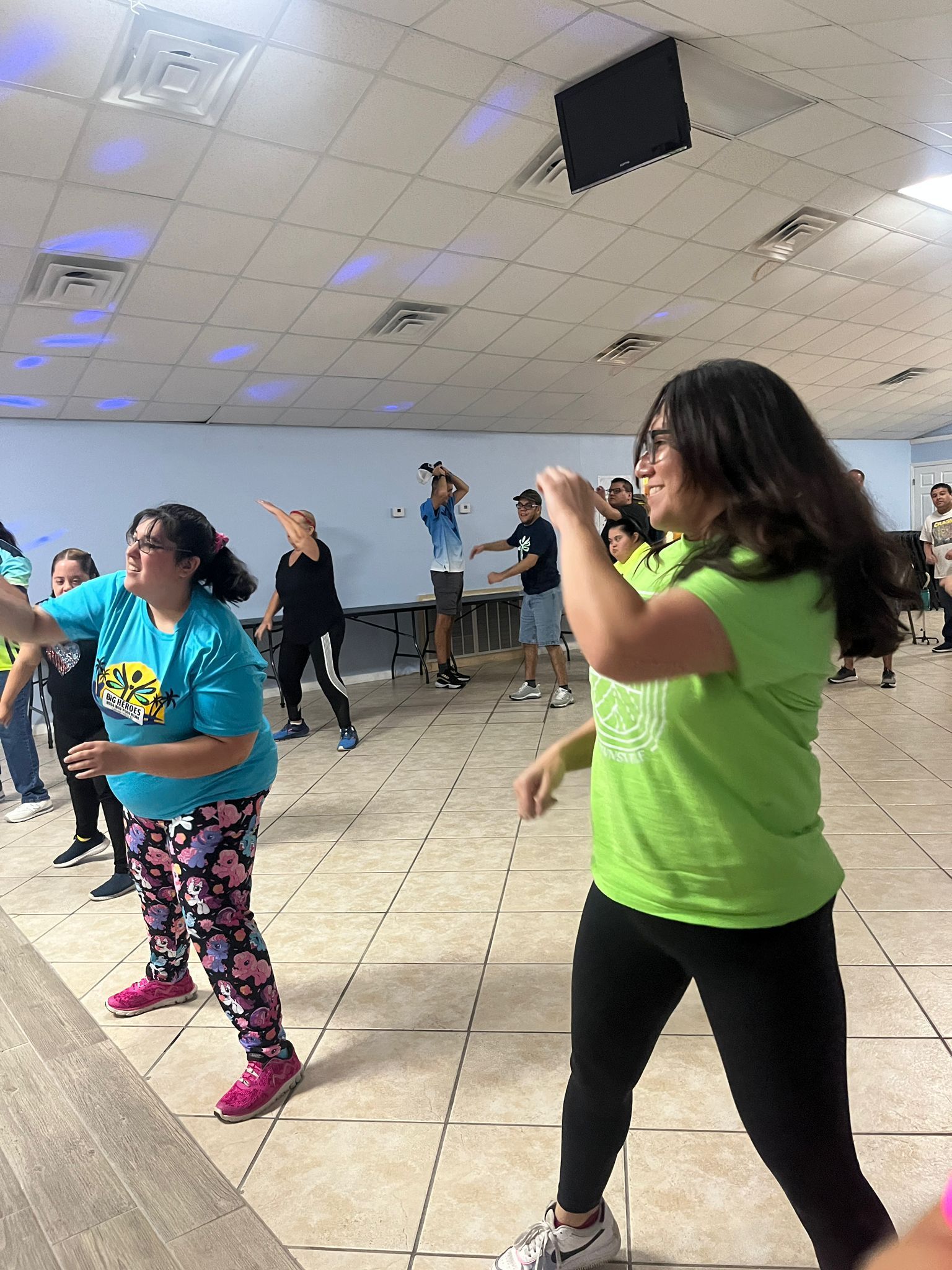 A group of people are dancing in a room.