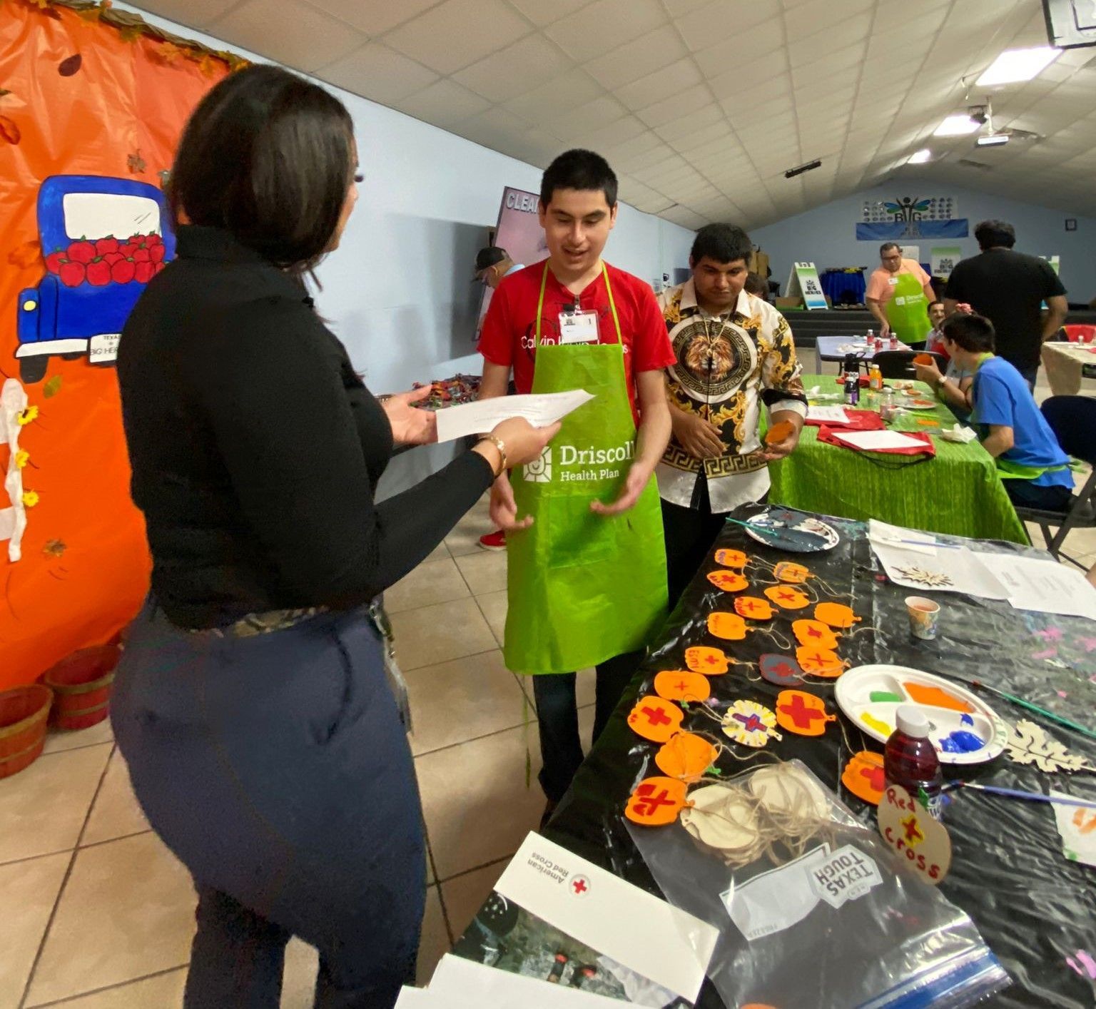 A man wearing a green apron with the word debbie on it