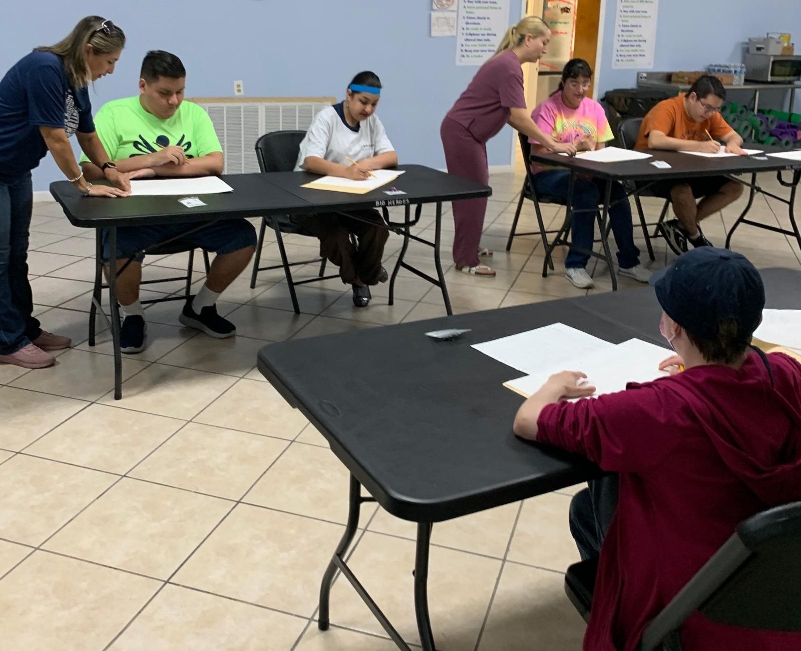 A group of people are sitting at tables in a room
